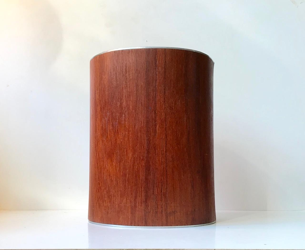 Mid-Century Modern cylindrical teak waste basket designed by Martin Åberg and manufactured by the Swedish company Servex. This particular model with aluminum top and bottom edges was commissioned by Emmery Wood Craft of Denmark during the 1960s.