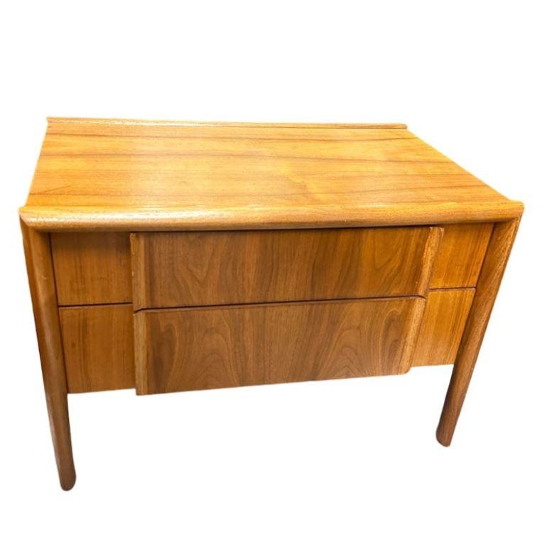 Presenting a small, stylish, and understated Mid-Century Modern walnut nightstand designed by Barney Flagg for Drexel Furniture's 