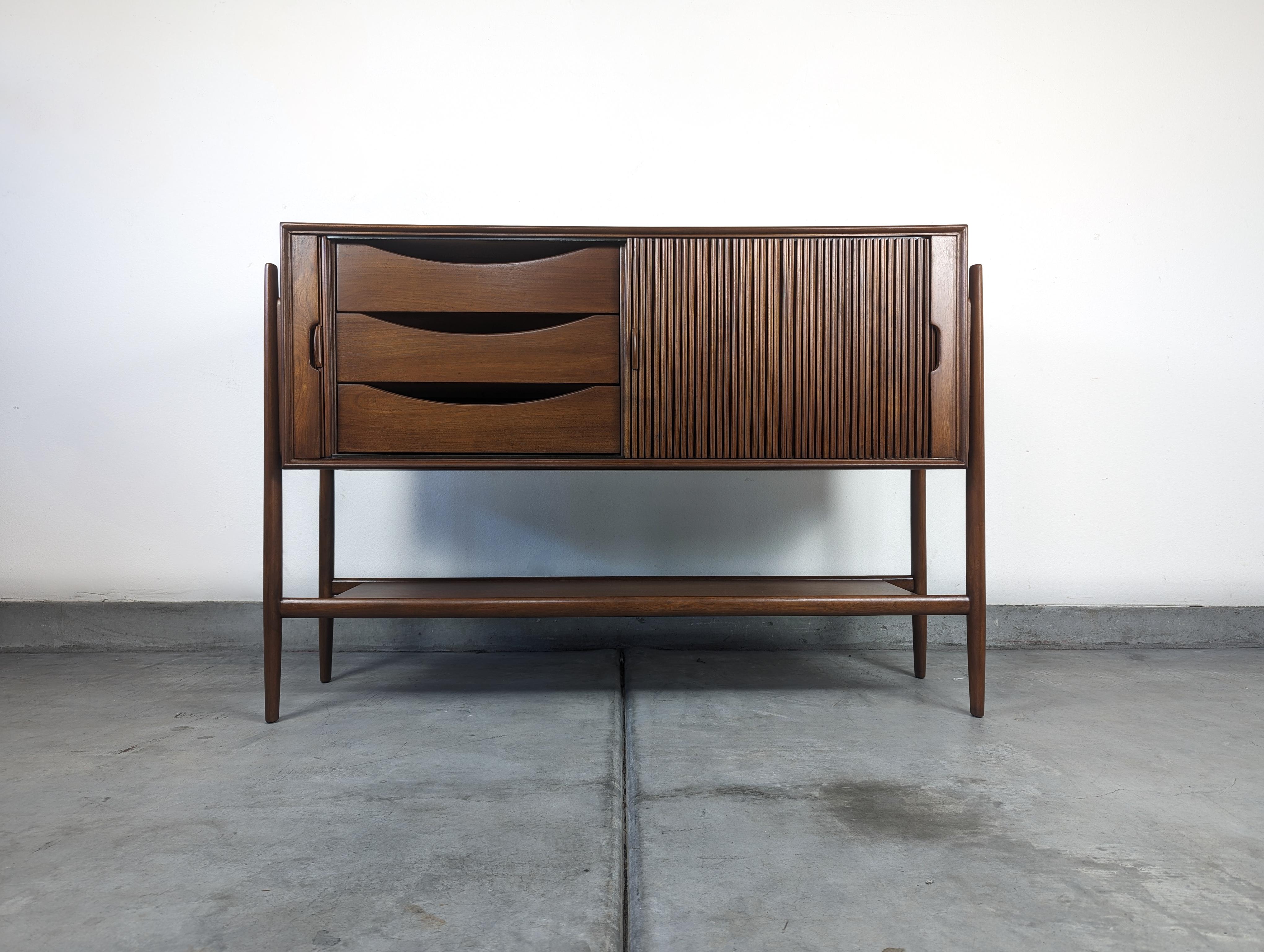 Indulge in the timeless elegance and exceptional craftsmanship of this vintage mid-century 