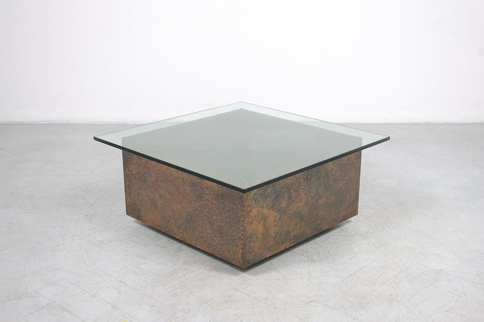 This organic modern vintage cocktail table is hand-crafted out of hammered zinc and glass and is in good condition entirely restored by our professional craftsmen team in the house. The coffee table is eye-catching and features a squared 3/8