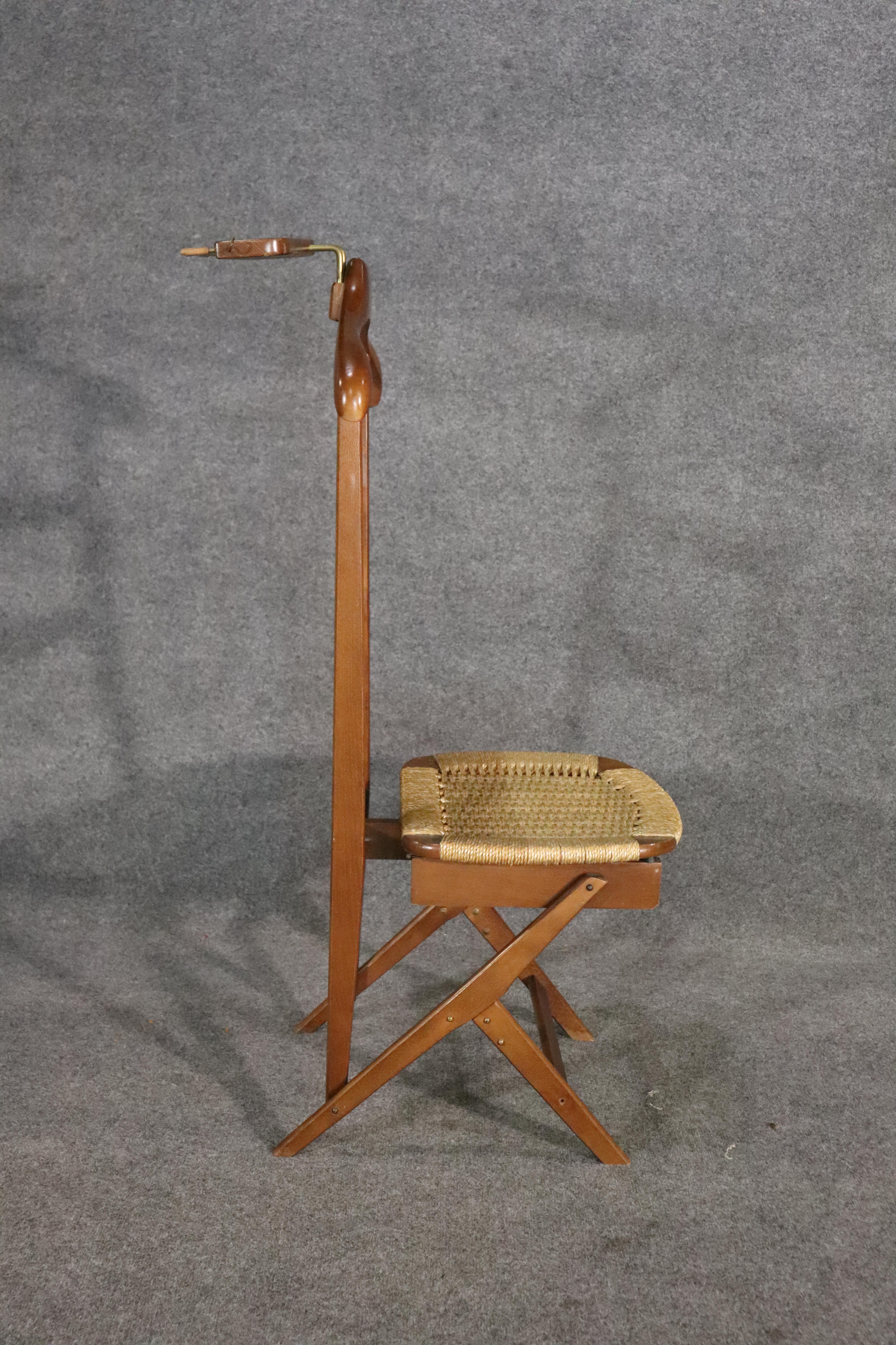 Mid-century modern butler chair by Ico Parisi and Luisa Parisi for Fratelli Regguitti.  Walnut frame with coat hanger and cuff link holder, with storage under the woven seat.
Please confirm location NY or NJ
