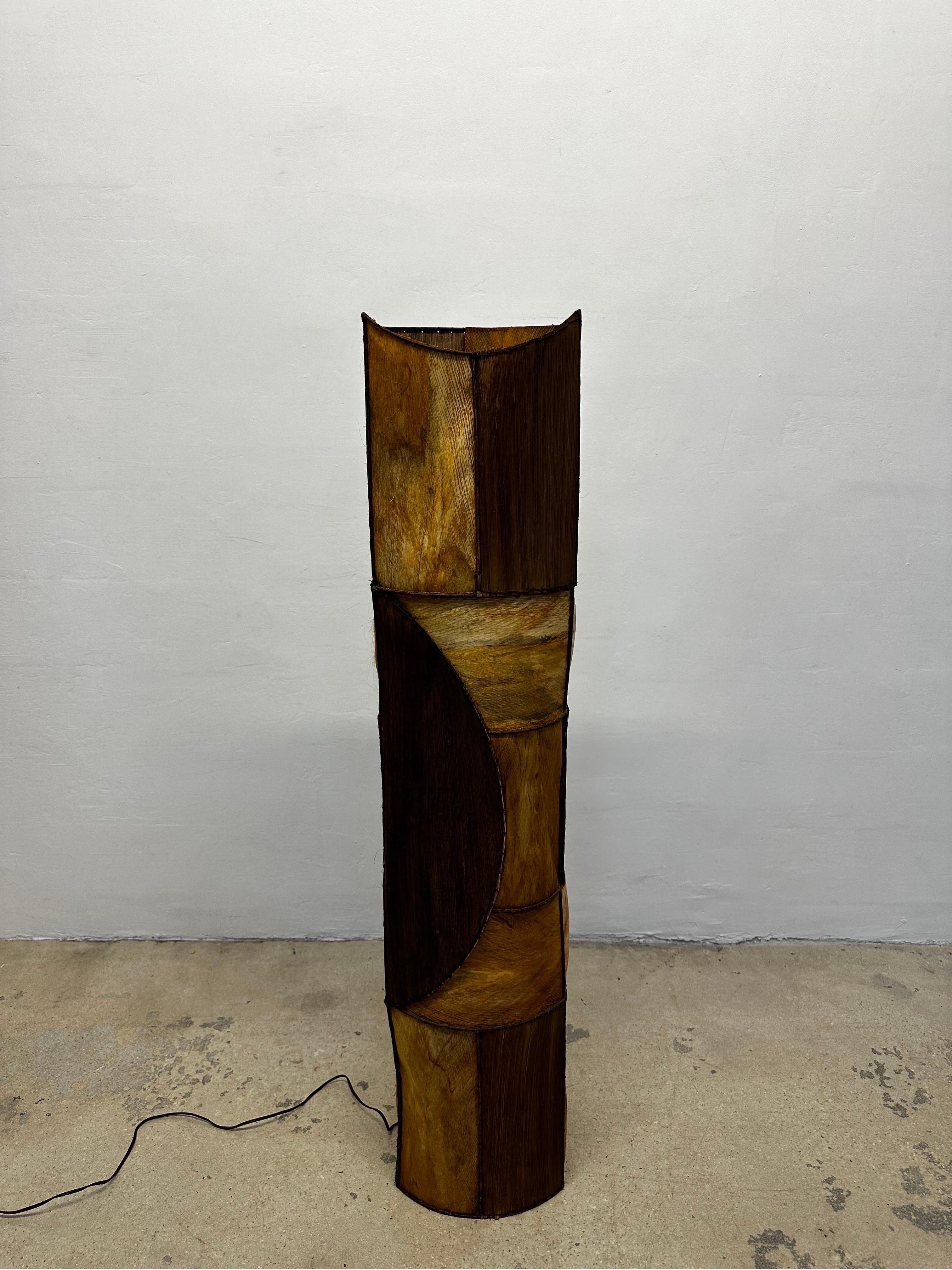 Patchwork bark skin over metal frame floor lamp with two interior bulbs and on/off foot switch from the 1960s.