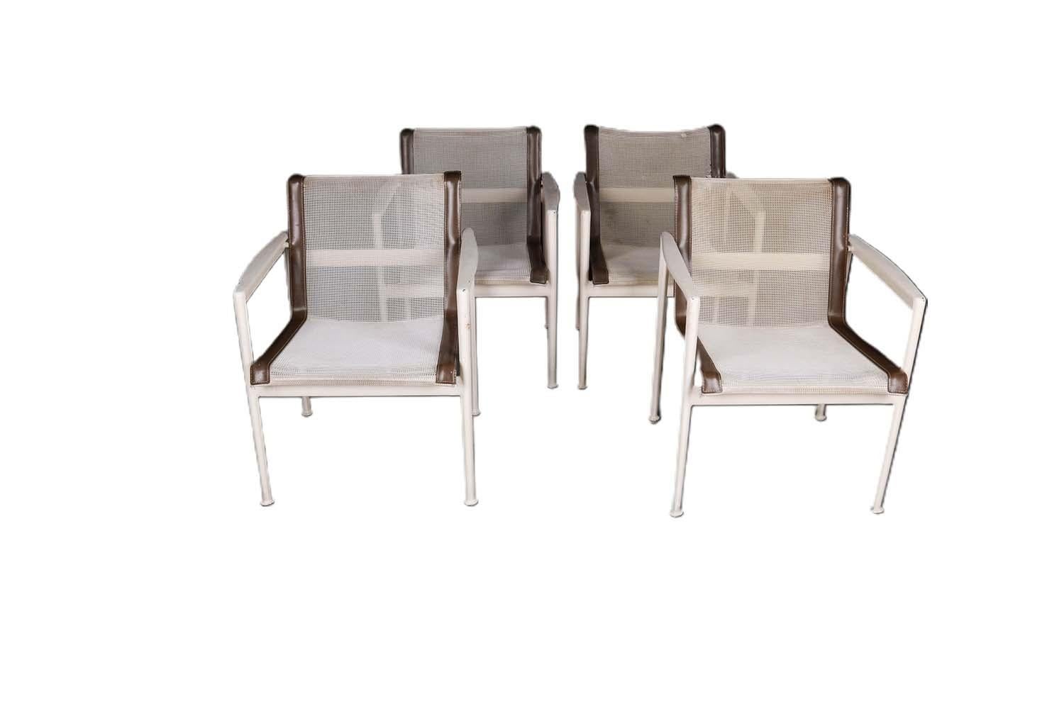 Set of four patio lounge armchairs by famous designer Richard Schultz for Florence Knoll, made in the United States, circa 1960's. Superbly crafted, each features aluminum white painted frames and signature woven mesh seats and backrest, in a white