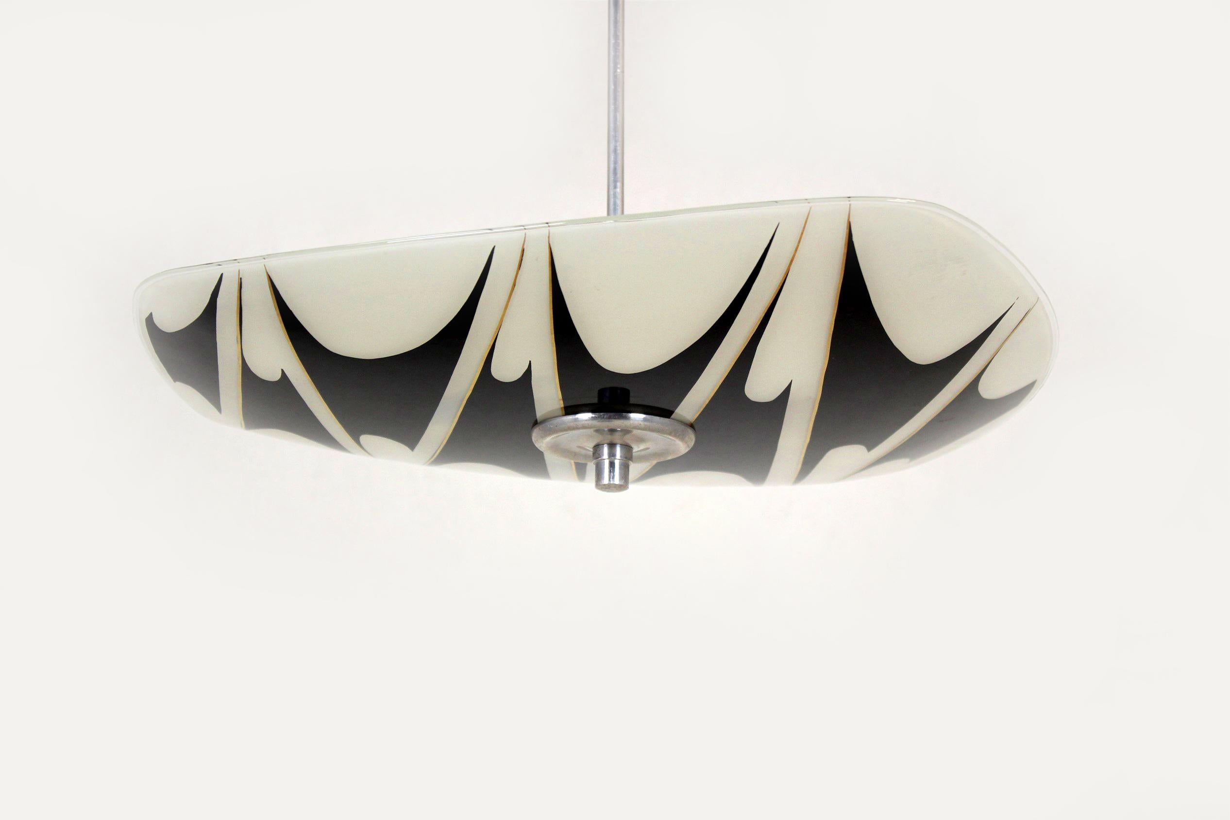 - Ceiling light dating made in the 1960s.
- Features a patterned glass shade.
- Made in former Czechoslovakia by Napako.
- The lamp is fully functional and requires three E27 bulbs.
 