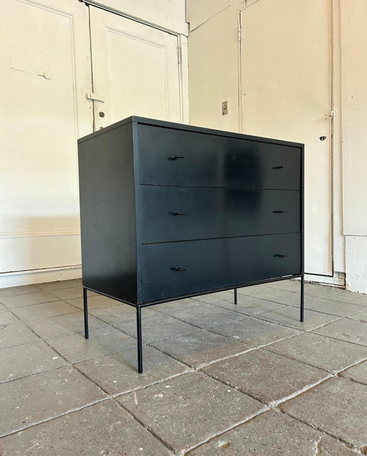 Mid-Century Modern black lacquer three-drawer dresser by Paul McCobb for Winchendon Furniture Company. All Original Black Lacquer paint finish with Blonde maple drawer insides. Black Steel T Pulls and Iron base. Labeled inside top drawer. Part of