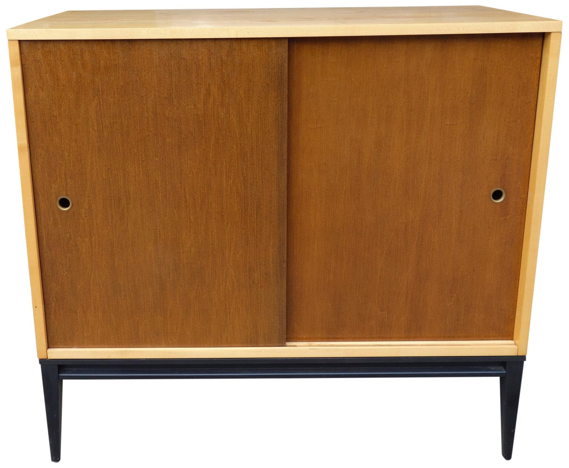 For your consideration is this wonderful sliding door cabinet designed by Paul McCobb -planner group- in excellent vintage condition and showing very little wear. Thoughtful proportions make this a very versatile case piece. This cabinet is made of