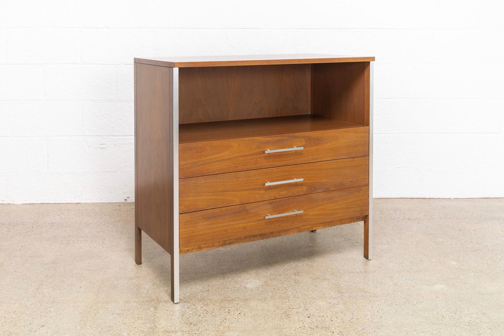 This vintage Mid-Century Modern Paul McCobb walnut chest of drawers was produced by Calvin Furniture circa 1950 as part of the Linear Group line. Expertly crafted from walnut, this Classic piece features sleek, geometric lines with signature Paul