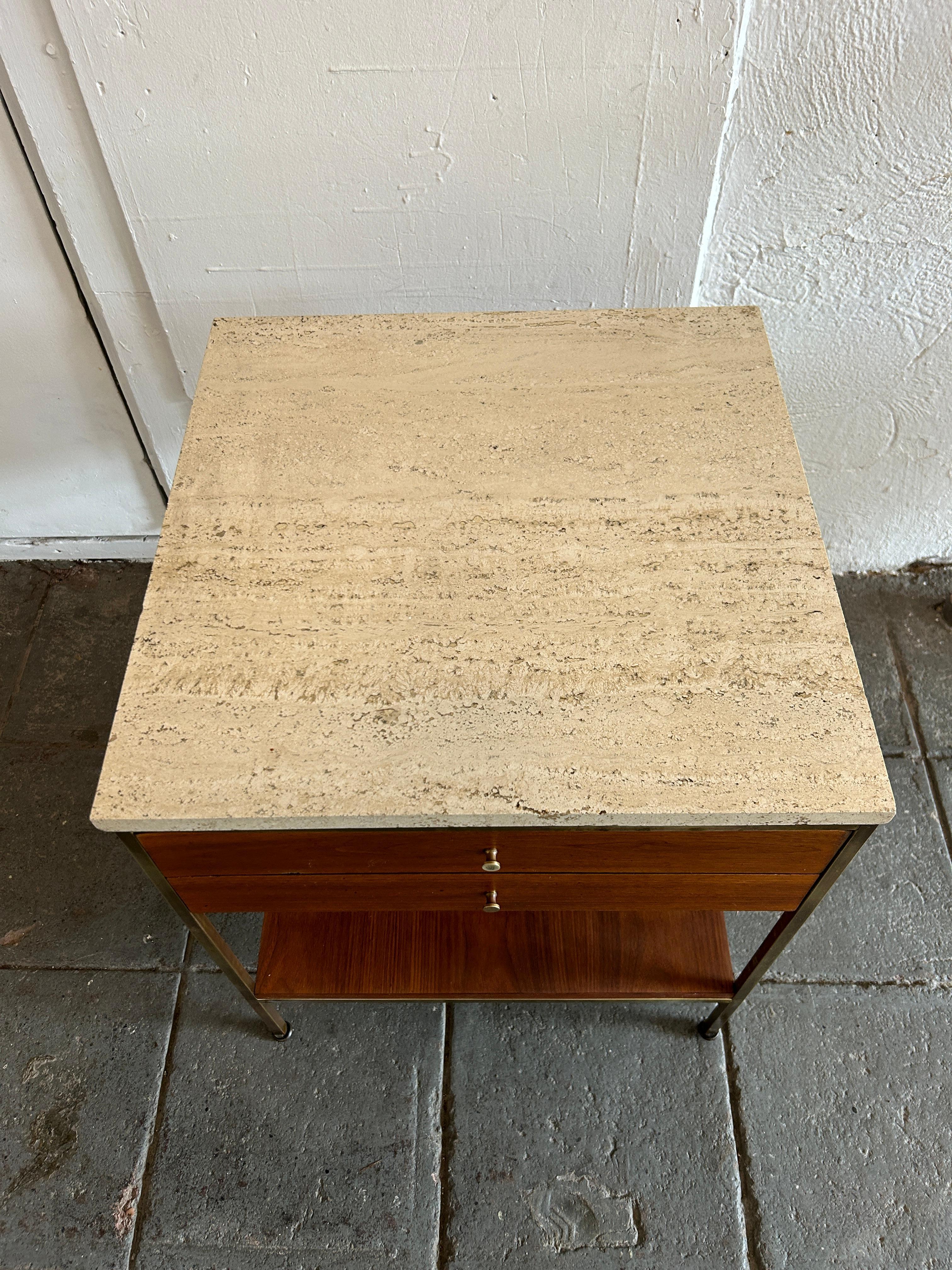 Beautiful Paul McCobb rare Single Nightstand / bedside table. Paul Mccobb collection by Calvin. Walnut case topped with Travertine Stone top on a brass base featuring two drawers and a lower walnut shelf. In vintage condition Brass shows patina and