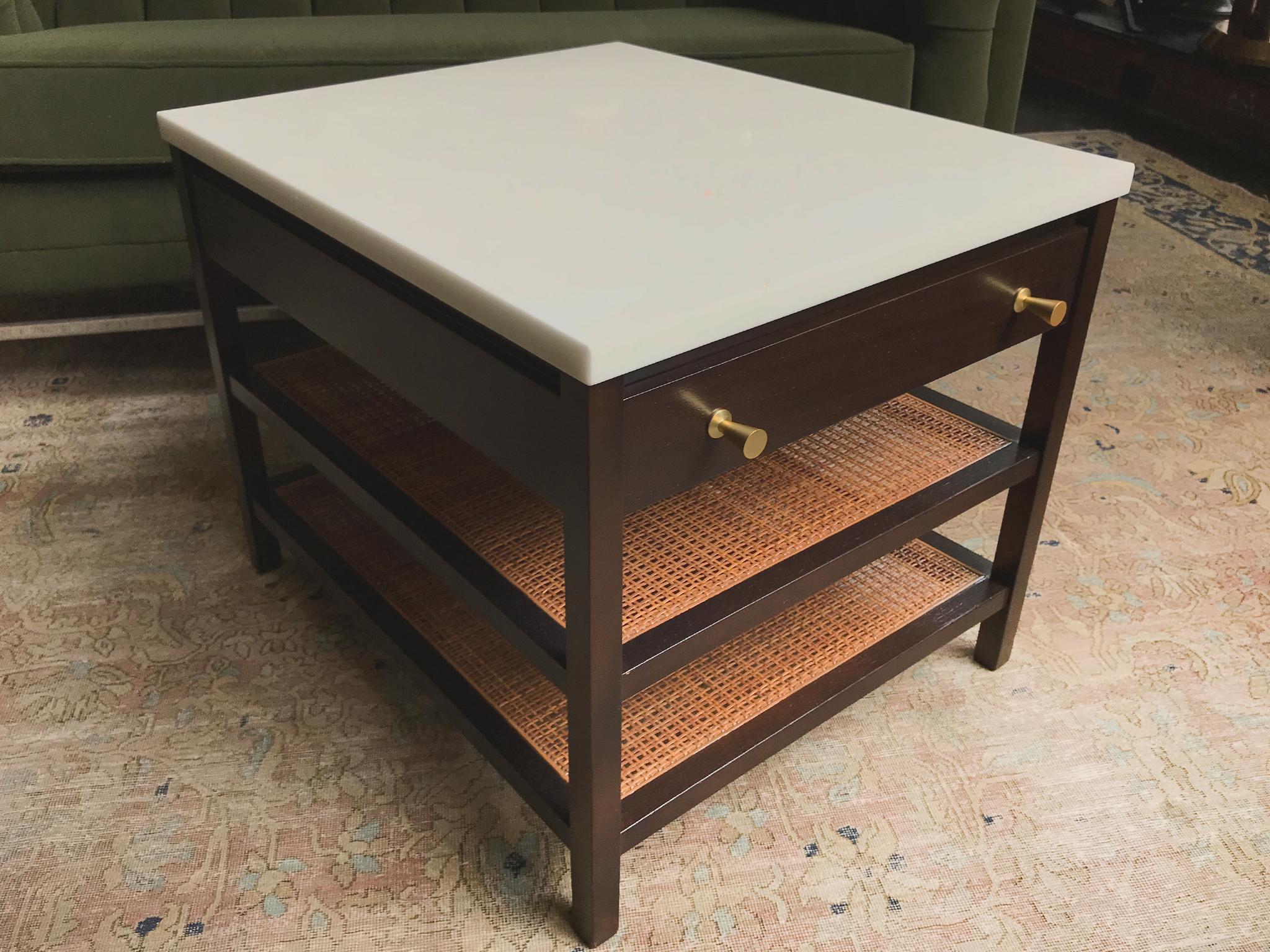 A handsome, minimal table designed in the 1950s by Paul McCob for his Directional line of furniture. It was manufactured by the Calvin Group. The table consists of an enamel-white marble top and mahogany base newly refinished in a warm, burnt umber