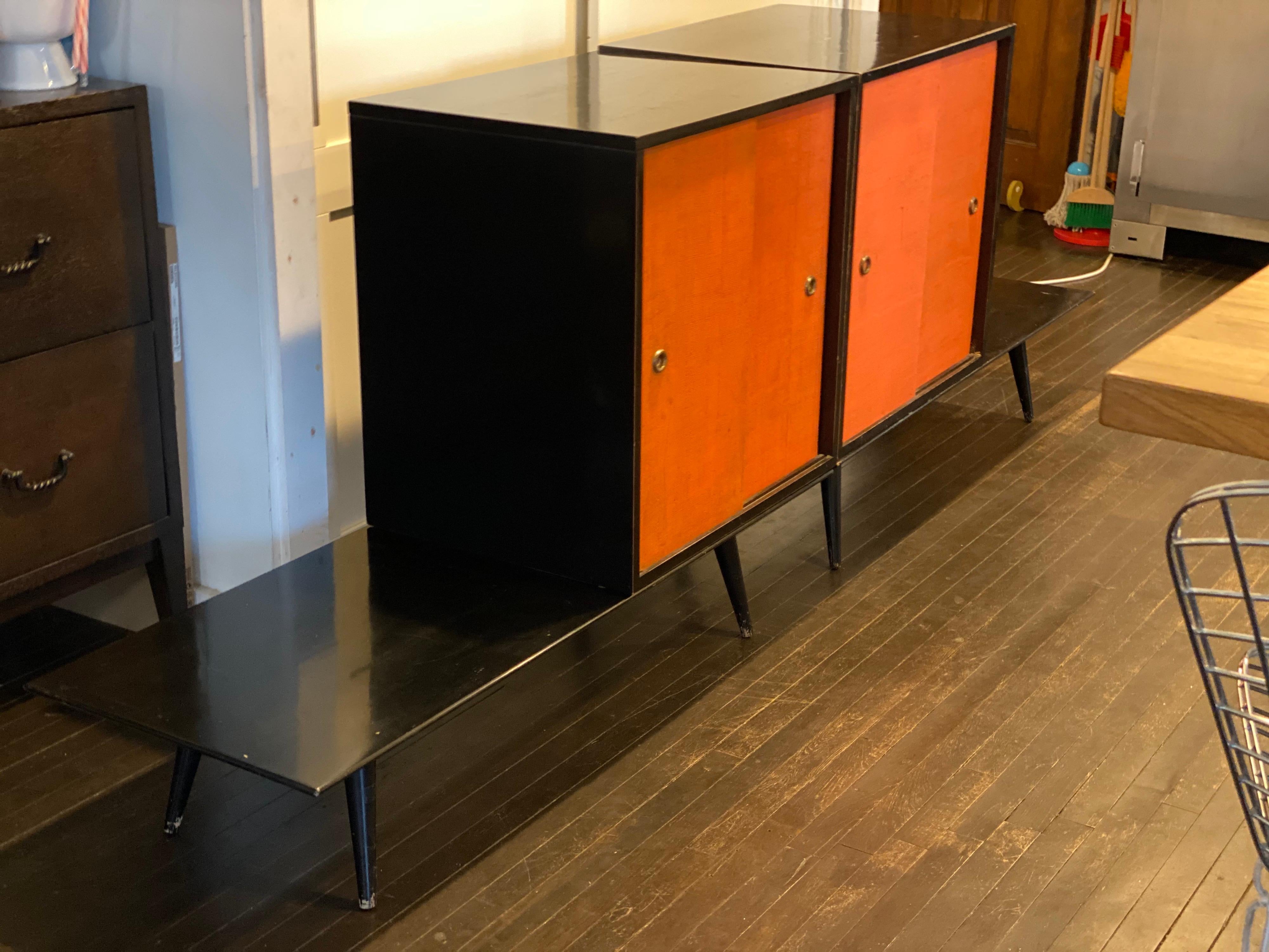 Midcentury Paul McCobb Planner Group four piece cabinets with benches in original orange doors with black lacquer finish.
Manufactured by Winchendon Furniture Company, 1950s.
This modular system can be set up in a few different combinations. Each
