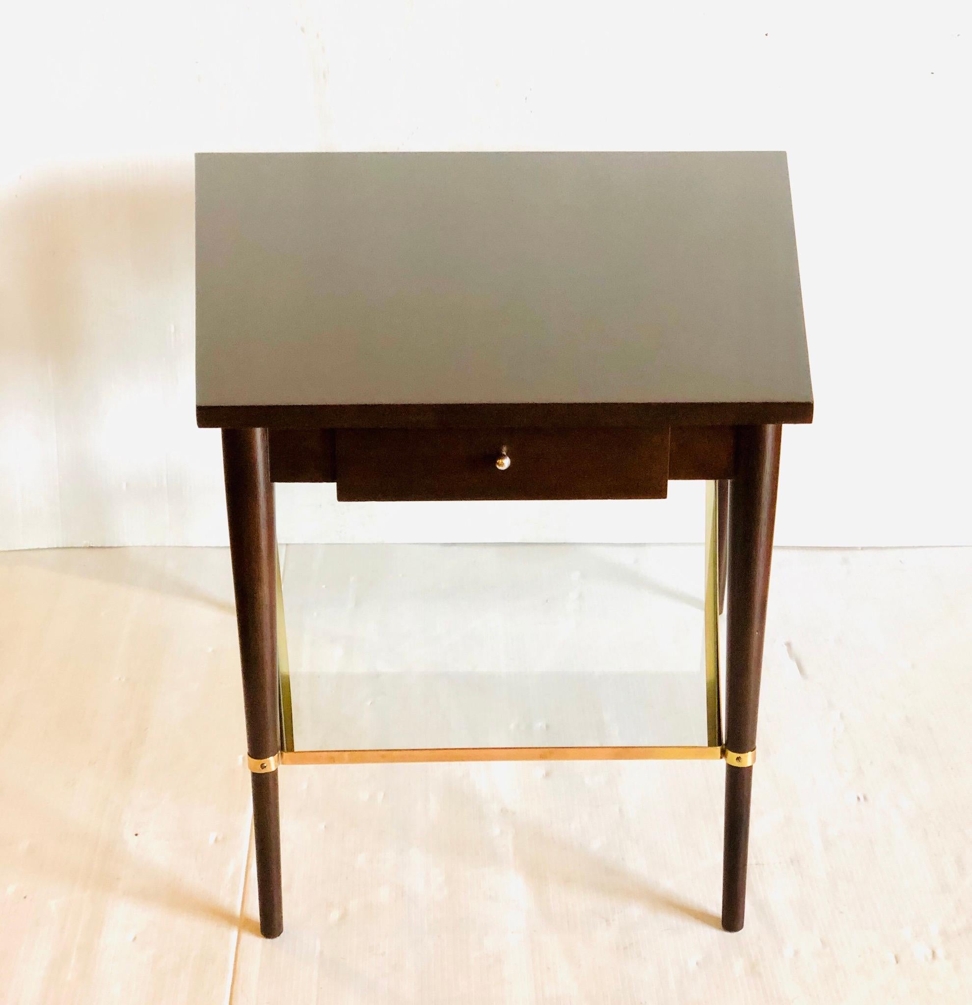 A very rare table designed by Paul McCobb for Directional designs, circa 1950s, mahogany stained in walnut finish, with brass fittings trapezoidal shape 26