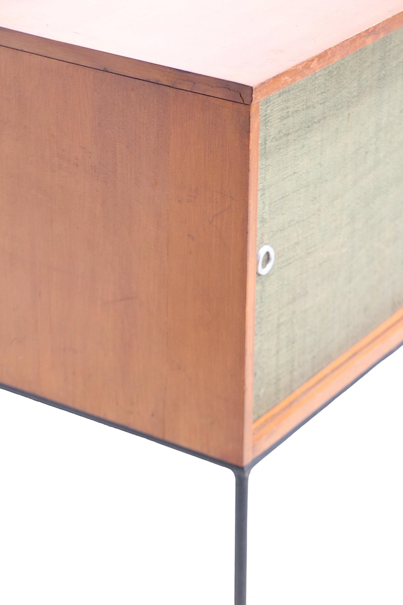 Hard to find Planner Group sideboard, designed by Paul McCobb for  Winchendon, circa 1950's. The cabinet features two grass mat sliding doors, with signature aluminum ring pulls, a blonde case, on wrought iron legs. 
 This example is structurally
