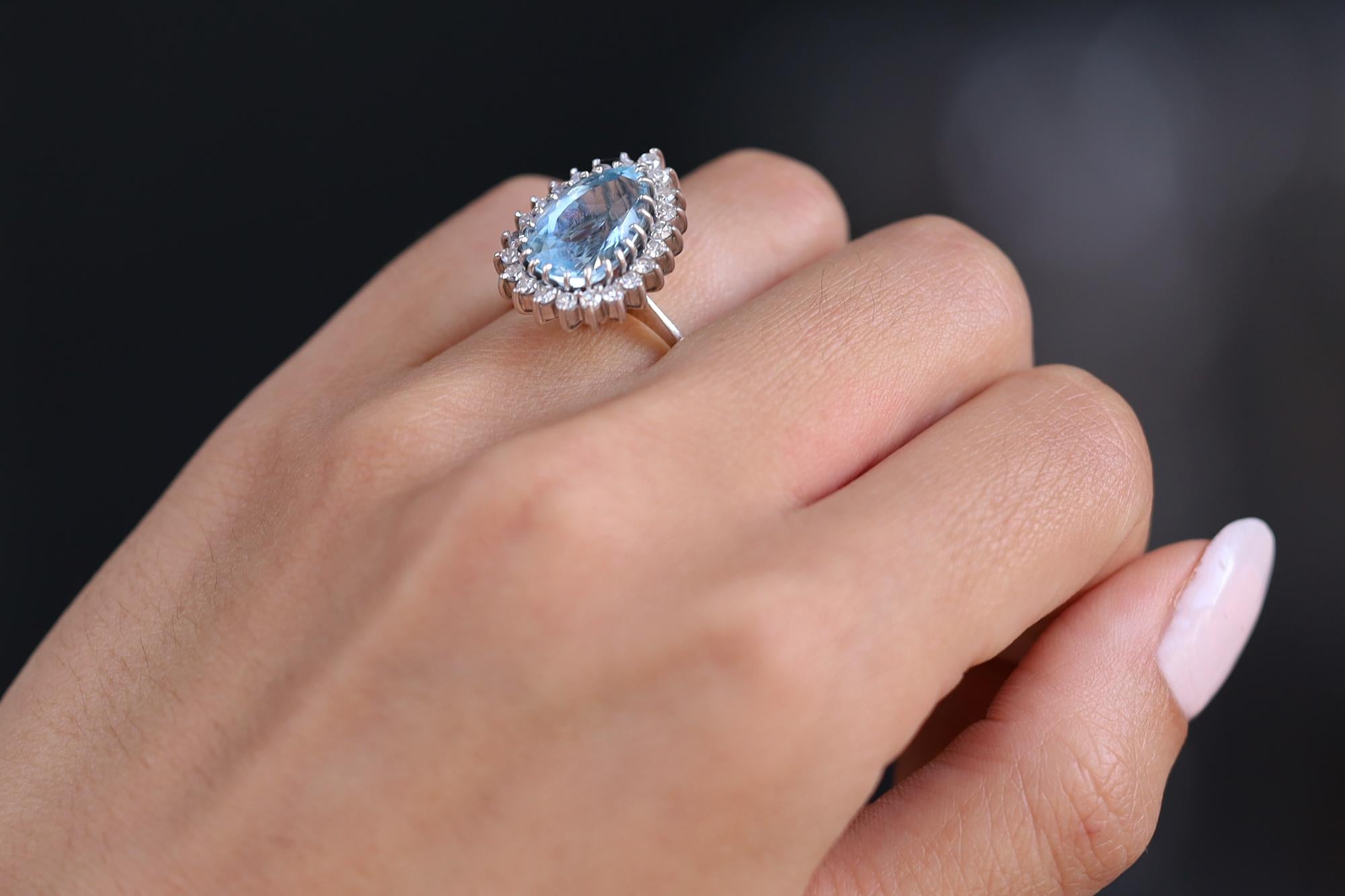 Expertly handcrafted with 18 karat white gold, this vintage estate cocktail ring features a stunning 4.25 carat vivid blue aquamarine gem from the famed Santa Maria, Brazil mine, cut into the popular pear shape. A versatile treasure, worn as a right