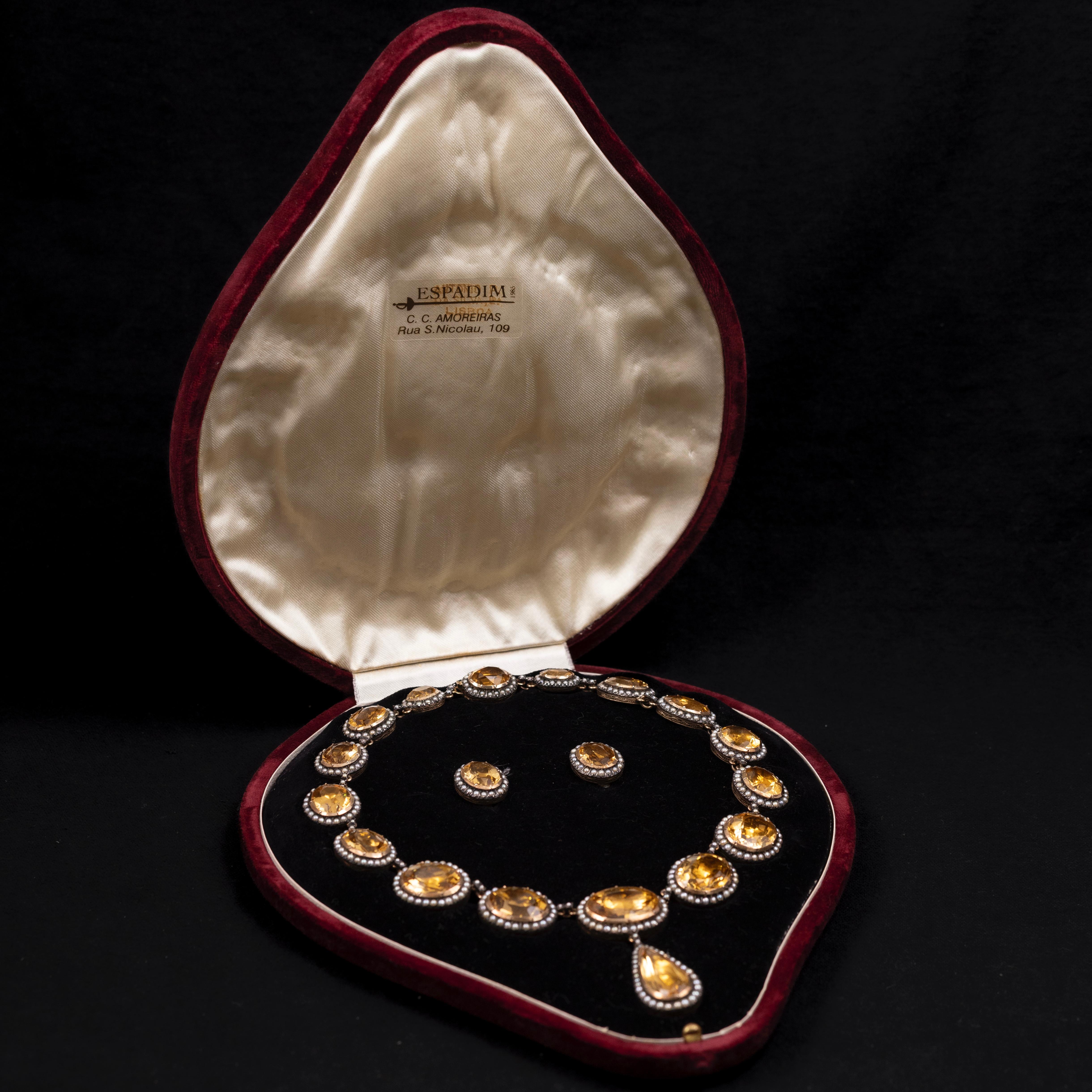 An exquisite Mid-Century citrine and pearl necklace and earrings demi-parure, crafted in silver and gold, and housed in a fitted presentation case. Designed in the 18th-century Georgian style by Portuguese goldsmith Américo Tavares Ferreira, this