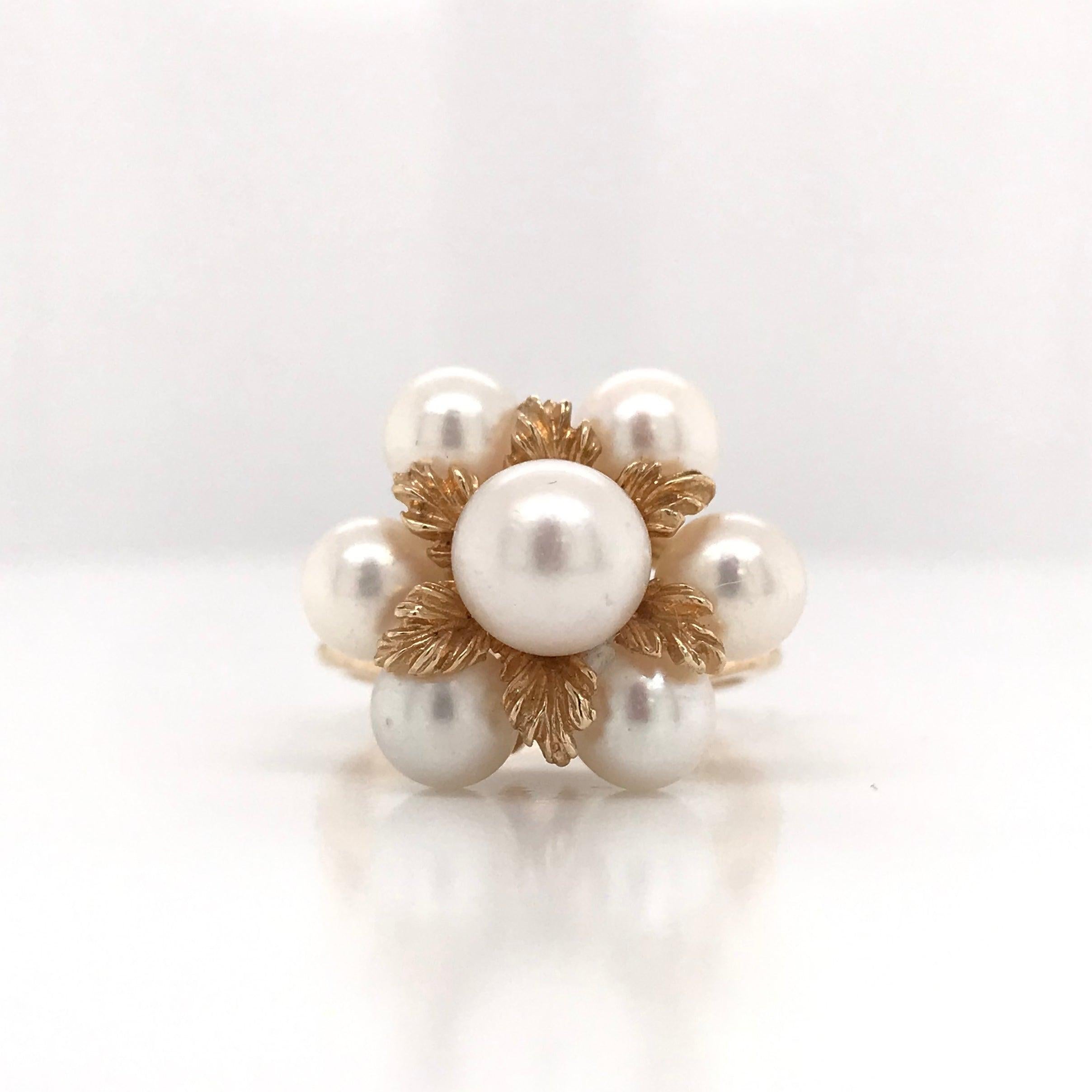 This piece was crafted sometime during the Mid Century design period ( 1940-1960s ). This charming Mid Century piece features 7 beautiful cream colored pearls with a slight blush. The pearls have a good luster and good complexion. The 14k yellow