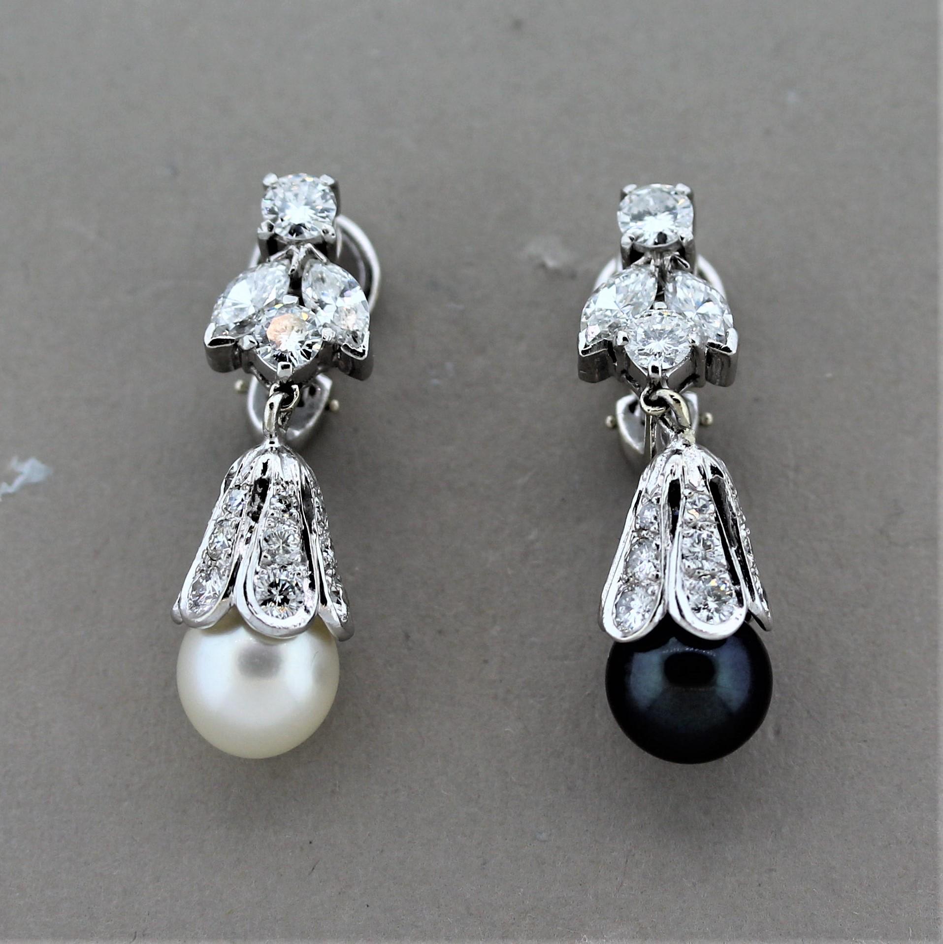 A pair of dazzling platinum mid-century earrings from the 1940’s. They feature two lovely pearls, one white and the other is black with a purple pistachio overtone. They are complemented by 2.50 carats of round brilliant-cut diamonds as well as