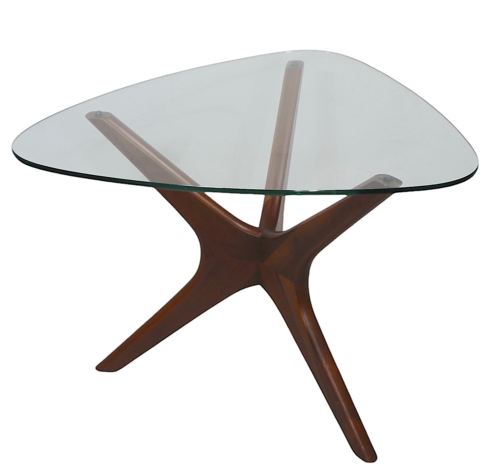 Iconic Mid Century end, or side, table designed by Adrian Pearsall, circa 1950/60’s.
 The table features a sculptural jack form wood base, with original guitar pick form thick glass top. This example is in very fine original condition showing only