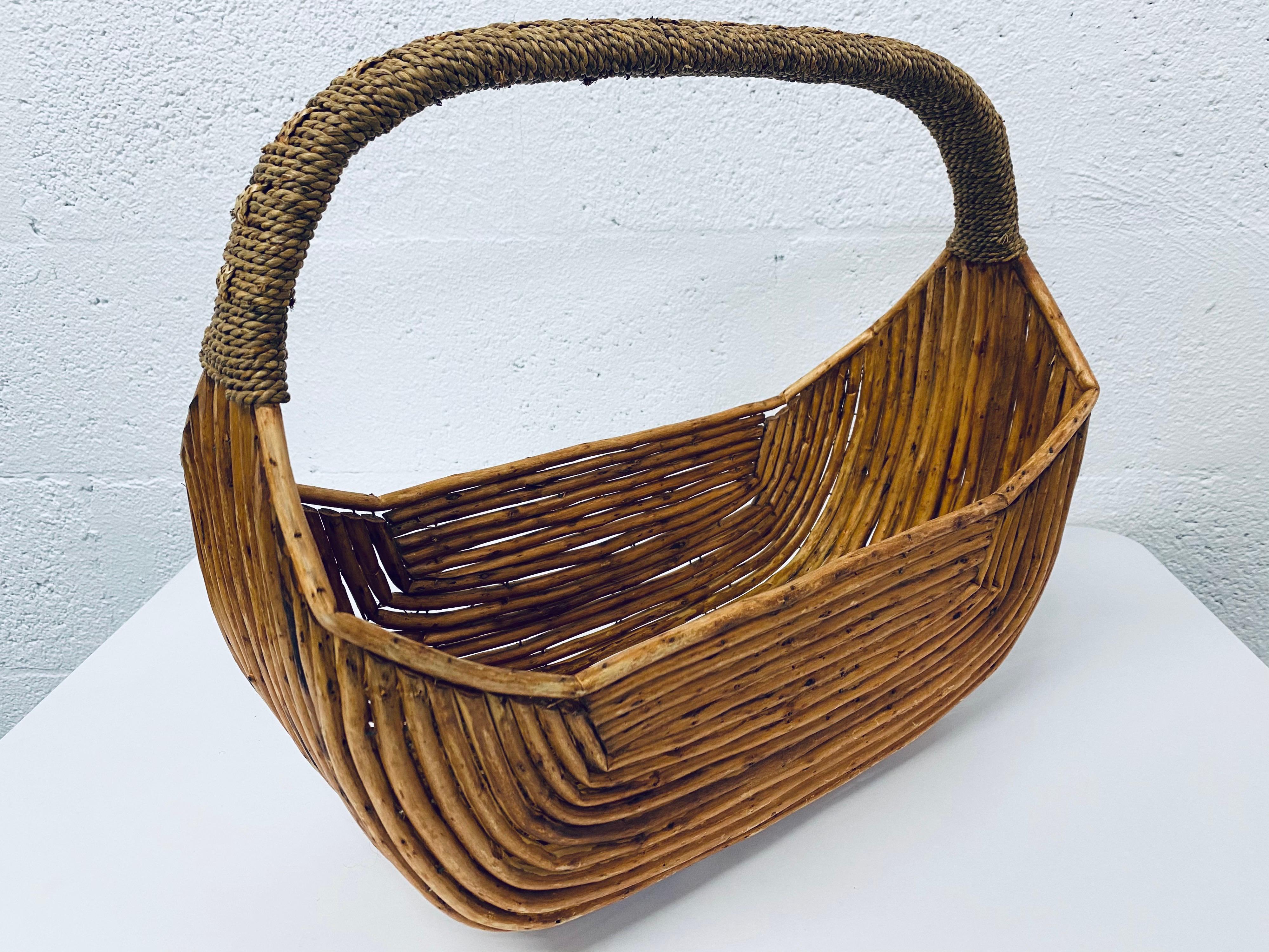 Midcentury pencil reed basket with woven rope handle.