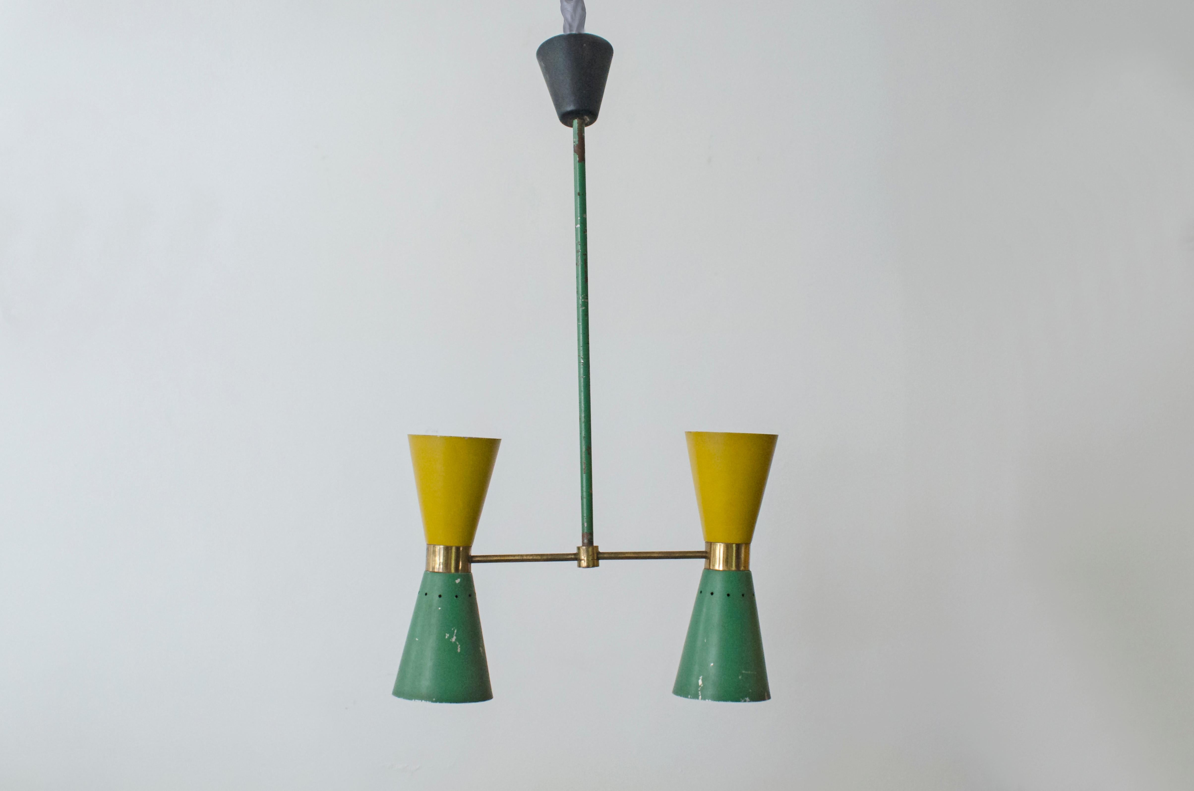 Pendant made of iron and bronze, painted green and yellow, by the Stilnovo house.

Stilnovo was a company founded by Bruno Gatta in 1946. Stilnovo is an important part of the first wave of post-World War II Italian design companies specializing in