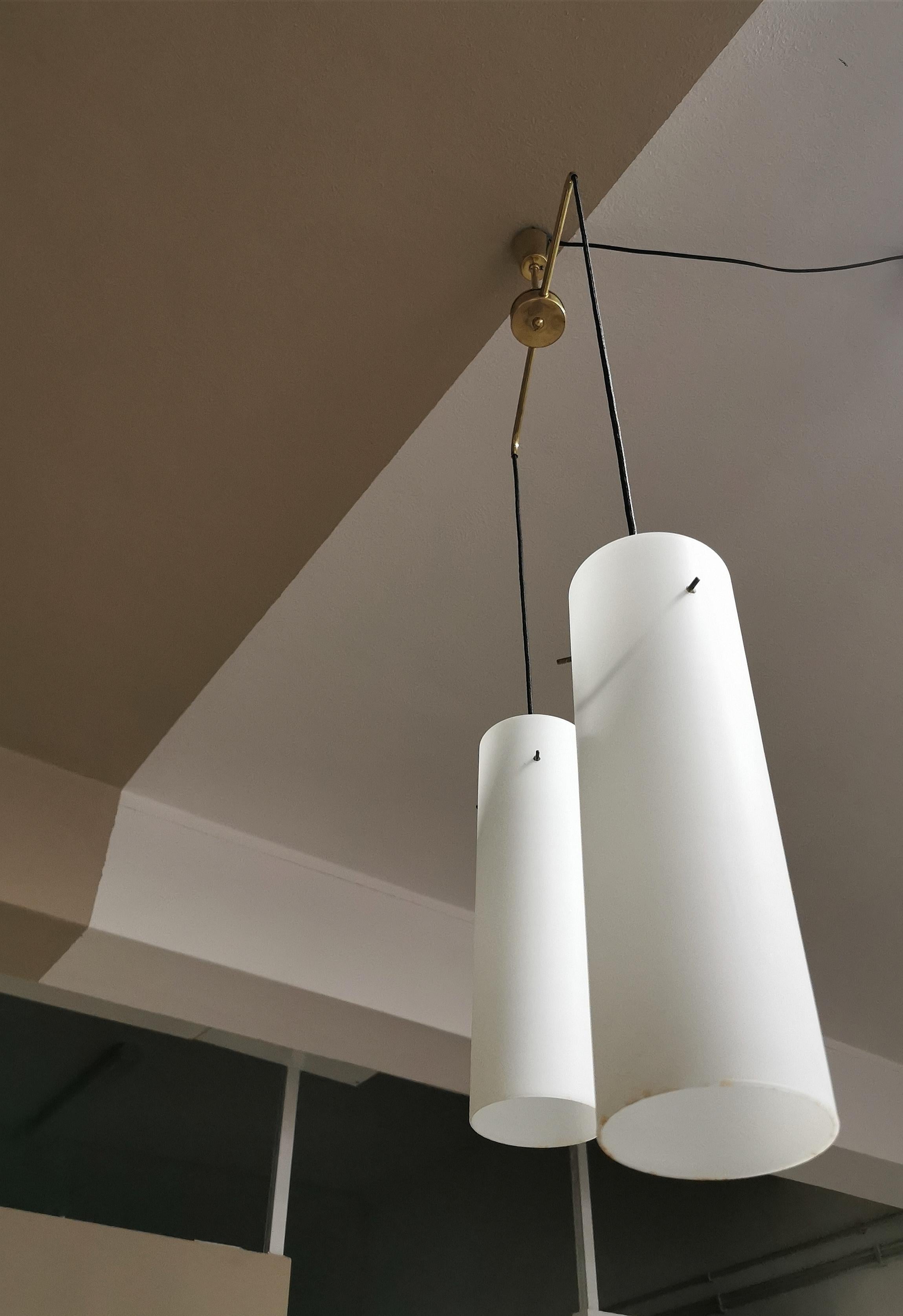Suspension with 2 pendants with 2 lights in opal glass with brass structure and two ropes that support the two diffusers. Italian production from the 1960s.