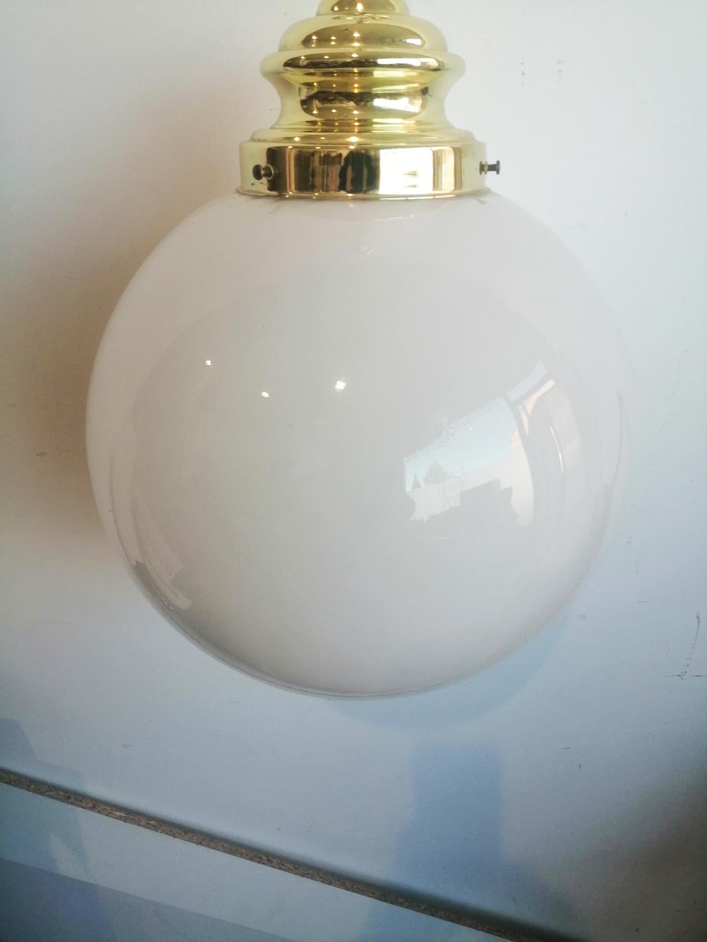 Mid-Century Modern metal crome chandelier, pendant or lantern with extra large globe in opal glass, Italy, 1950s or 1960s

This beautiful lamp is very large to be a crystal ball and is suitable to illuminate the entrance of your house or a