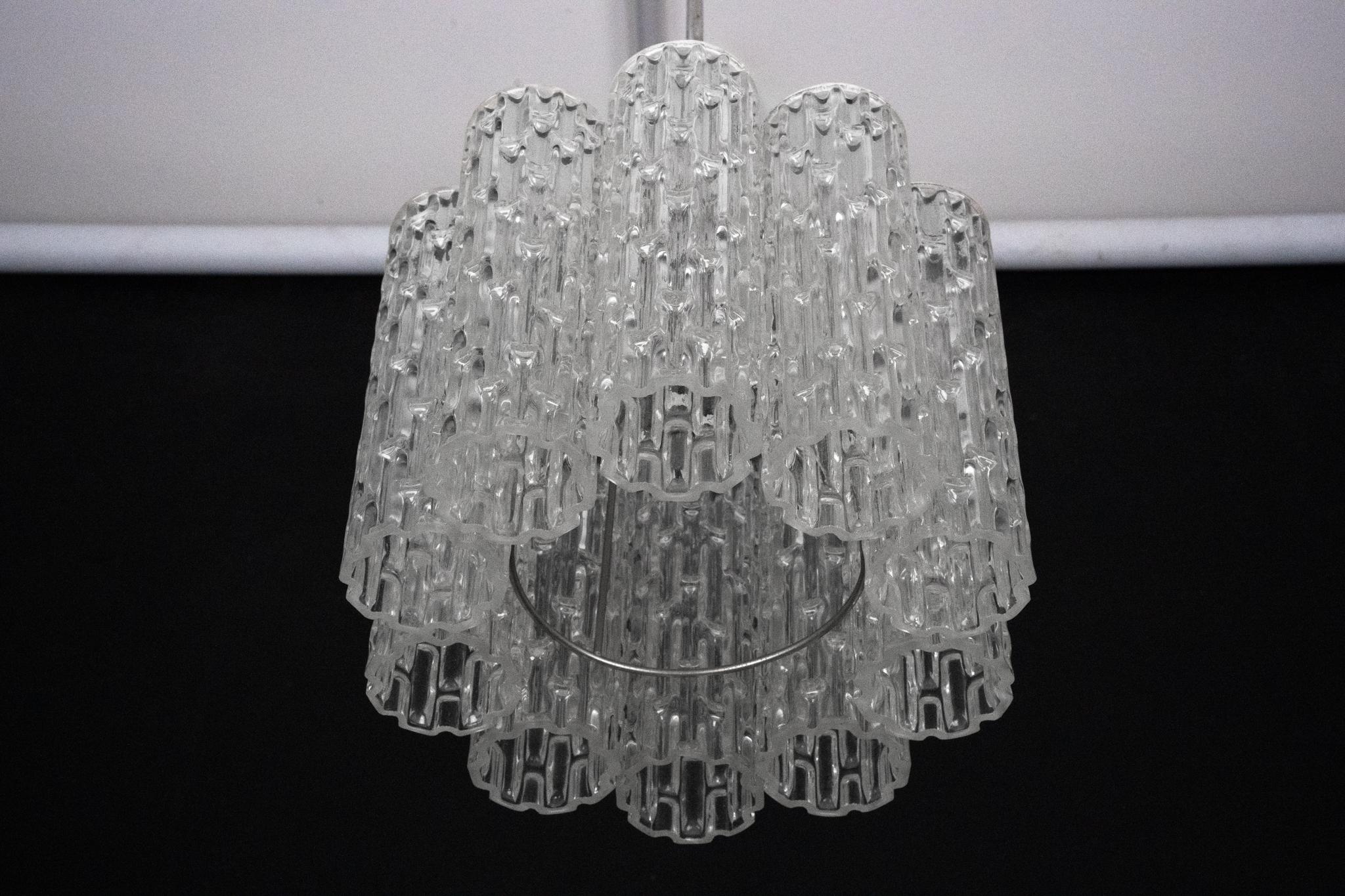 Elegant Mid-Century pendant light crafted in Italy during the 1960s, featuring a refined composition of Murano glass elements and a sleek chrome structure. The combination of high-quality materials and timeless design makes this piece a perfect