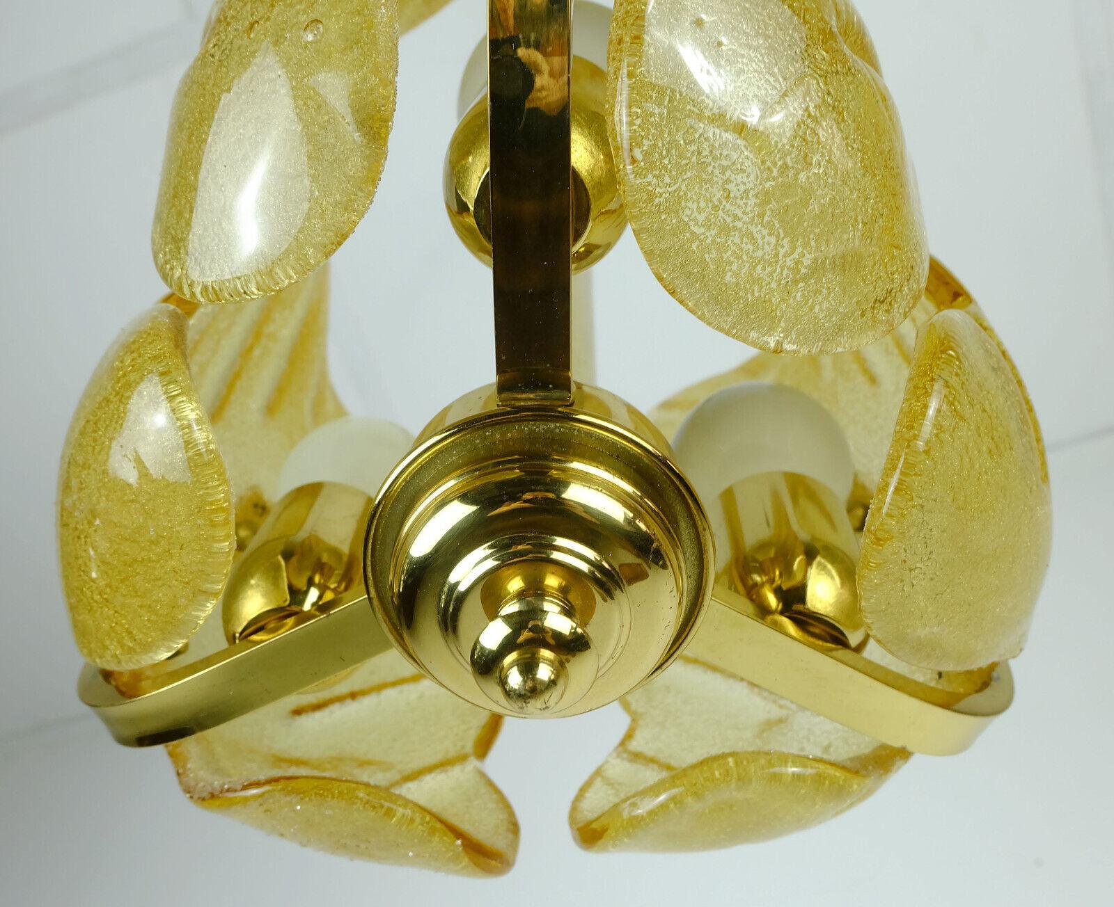 Small 1960s chandelier / pendant lamp with 3 leaf-shaped elements in amber colored ice glass. The frame is made of brass. With 3 sockets for E27 light bulbs. No label, probably manufactured by Soelken-Leuchten.

Very good condition, no damage,