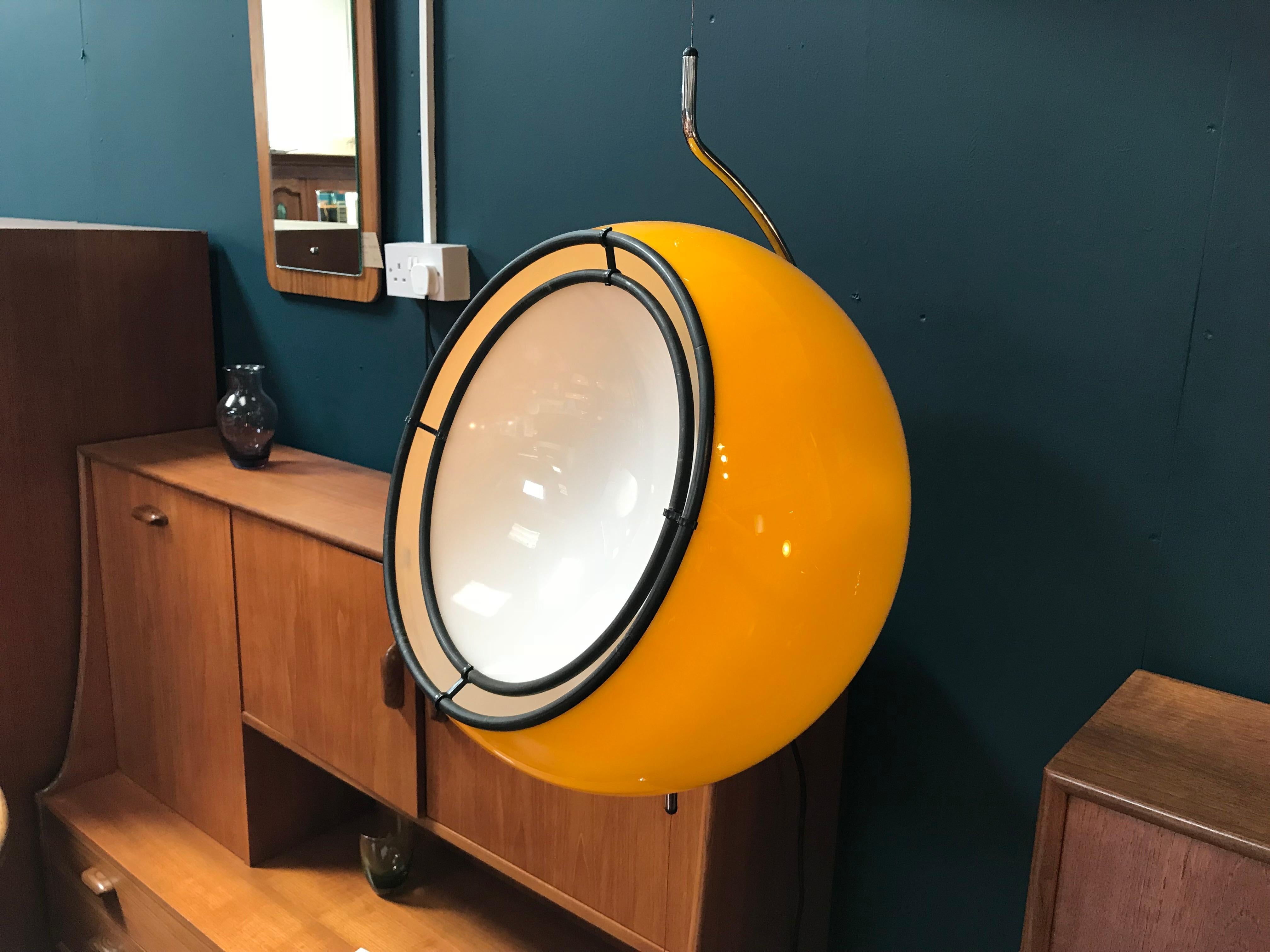 This pendant lamp with a counterweight was made in Italy in the 1970s is reminiscent in style of pieces by designer Gae Aulenti for Harvey Guzzini. This rare yellow version still has its original ‘Guzzini’ label attached and intact.

The yellow
