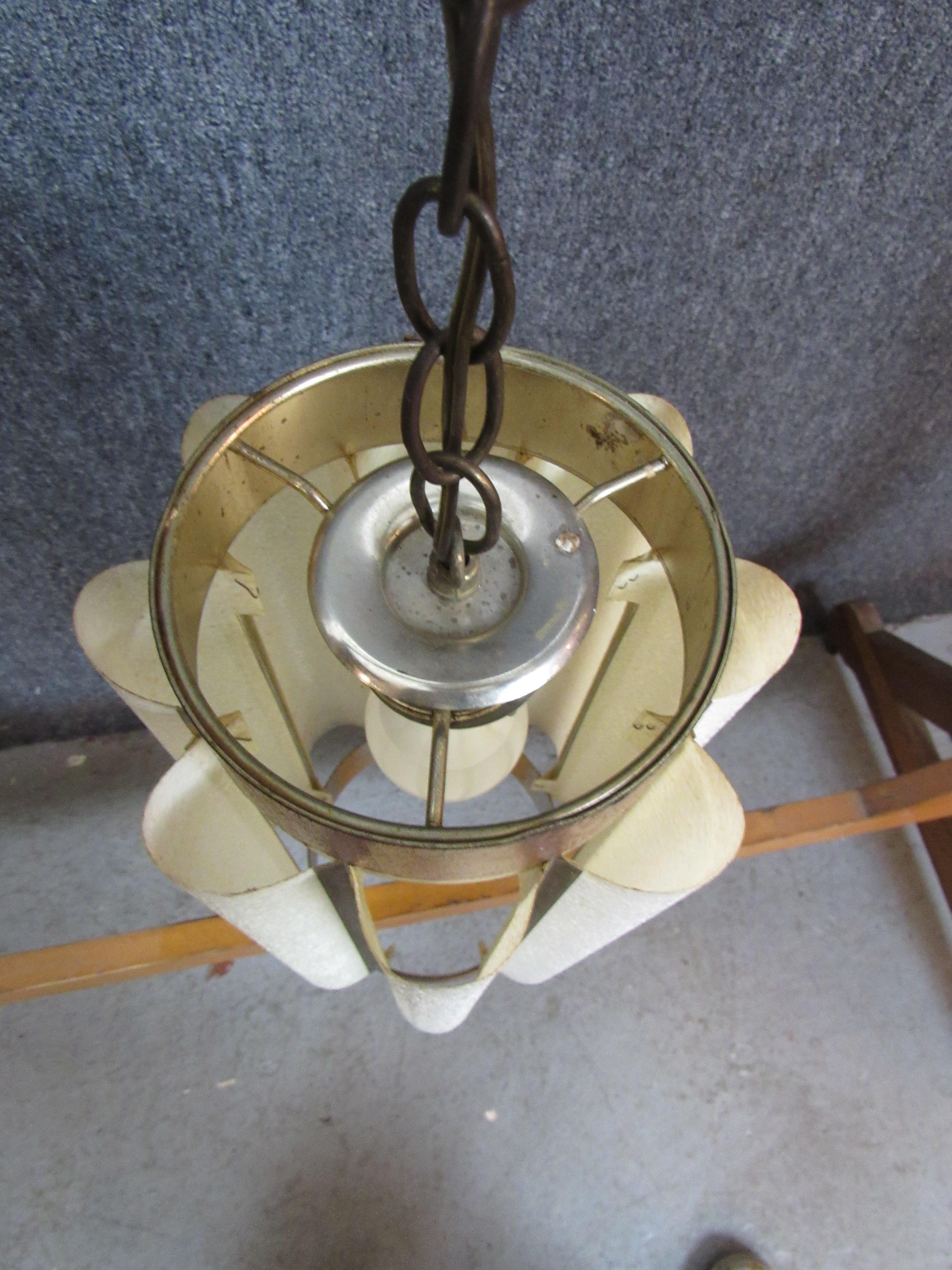 Mid-century modern hanging lamp with fluted paper shades around a wood frame. Single medium base socket under white shades give a subtle glowing light.
Please confirm location NY or NJ