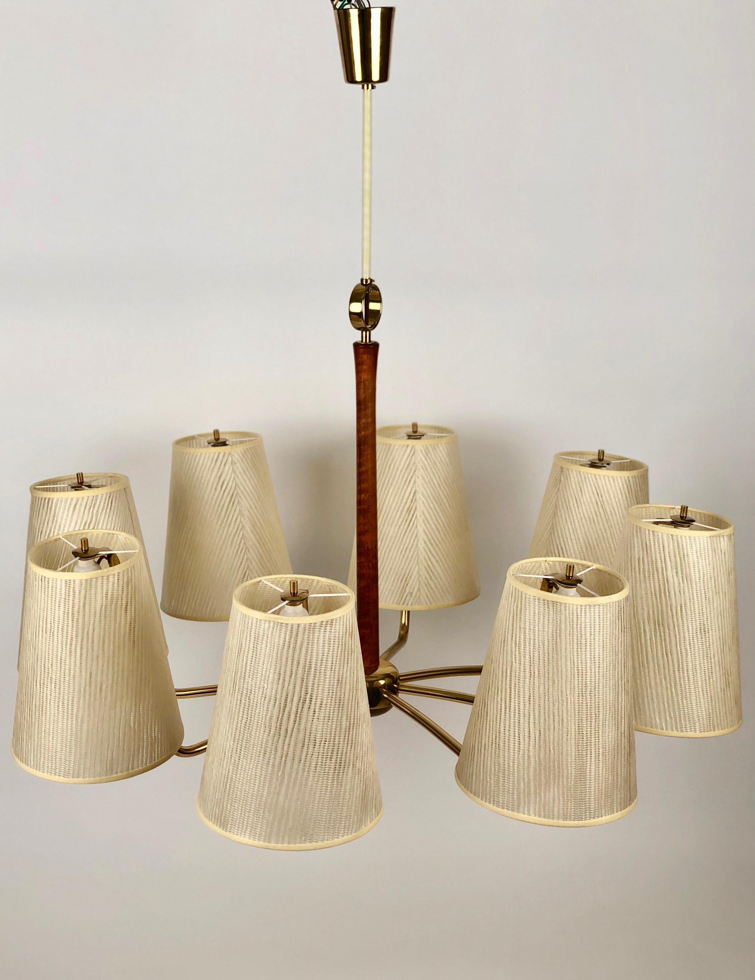 A beautiful pendant lamp from Josef Frank. This 7 arm lamp in brass with walnut accents
is simply a Wow! The subtile accents in wood and brass make this piece very sublime 
in its design. The shades are composed of synthetic fibres and resin and