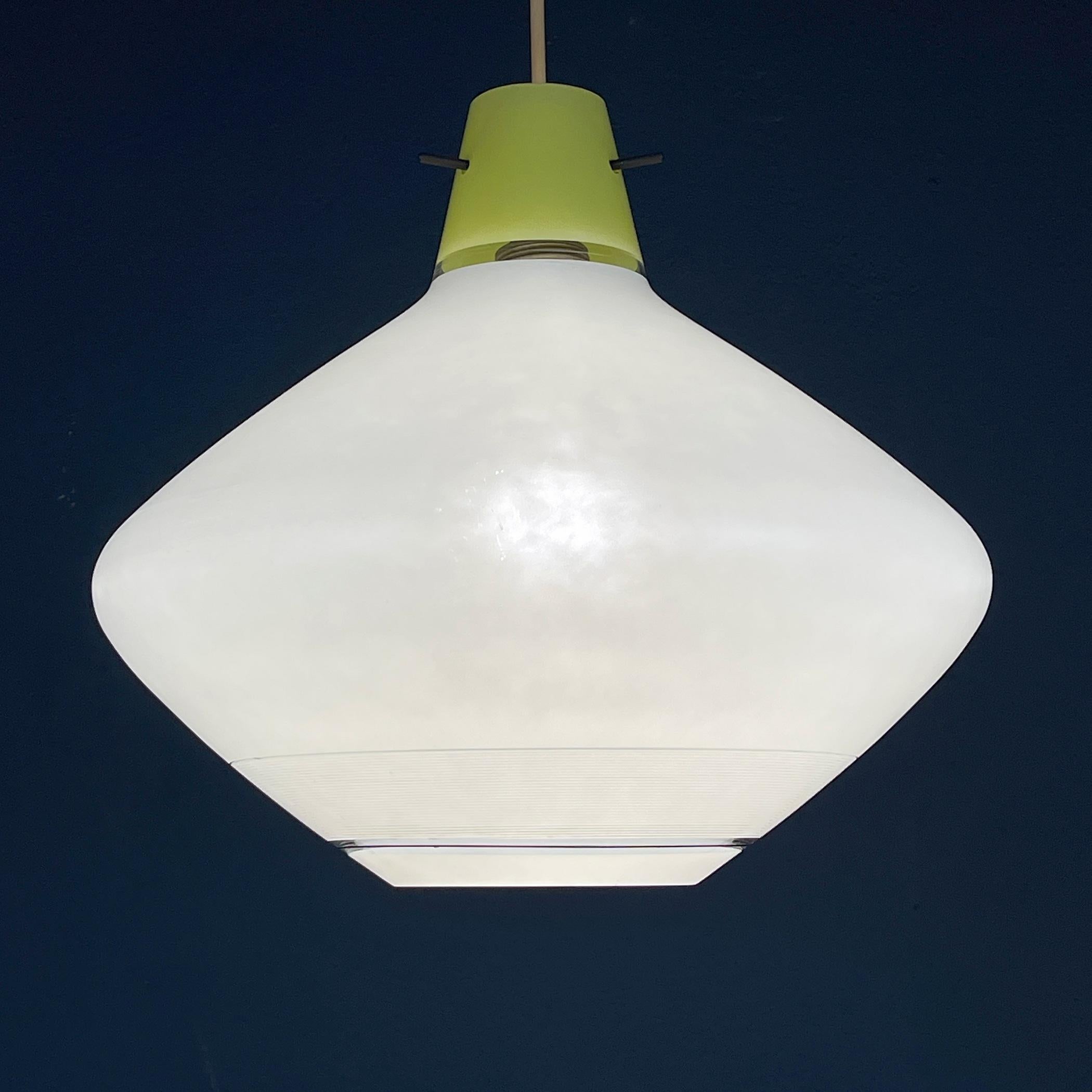 Explore the vintage elegance of this white pendant lamp, crafted with exquisite artistry in Italy during the 1950s. This magnificent piece bears witness to the skill and dedication of master glassblowers who poured their expertise into its creation.