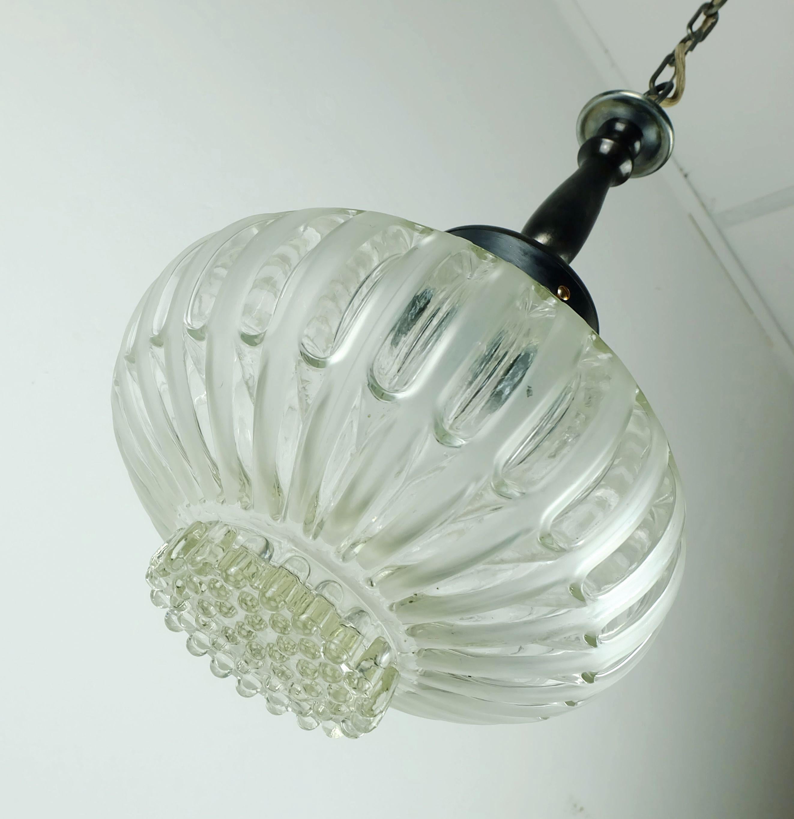 A fantastic vintage 1960s hanging lamp. The shade is made of thick glass, clear glass and satin glass. The base, chain and canopy are made of gray metal. Textil wire.

Overall length 41 3/4