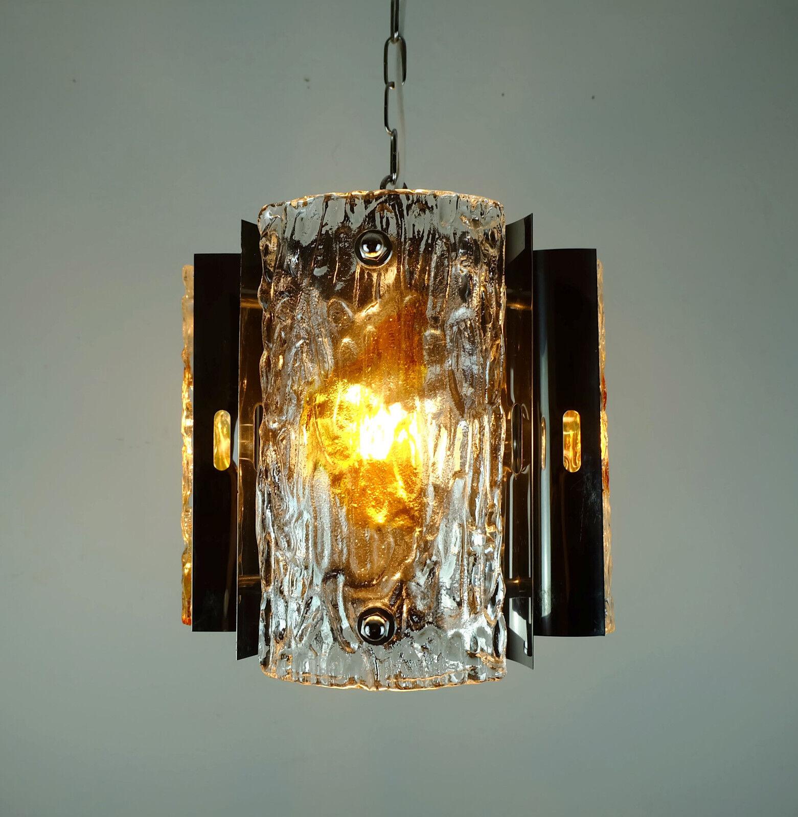 A very beautiful 1960s to 70s midcentury pendant. No label, most probably made by Mazzega, Italy. Made of chromed metal and 3 curved square disc made of thick transparent ice glass with amber color inclusions. Holds 3 E14 bulbs. The bulbs shown in