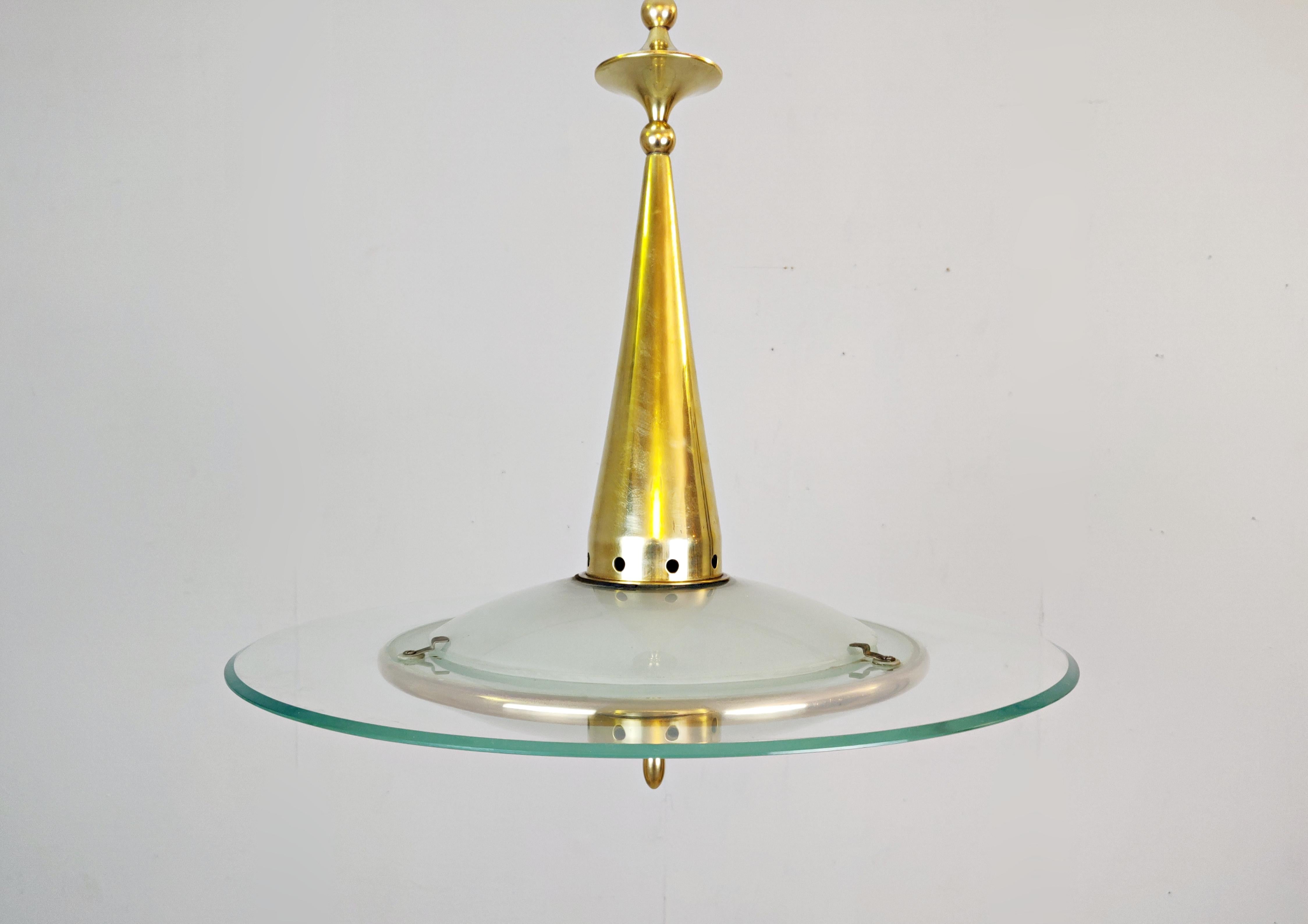 Midcentury pendant light in glass and brass.