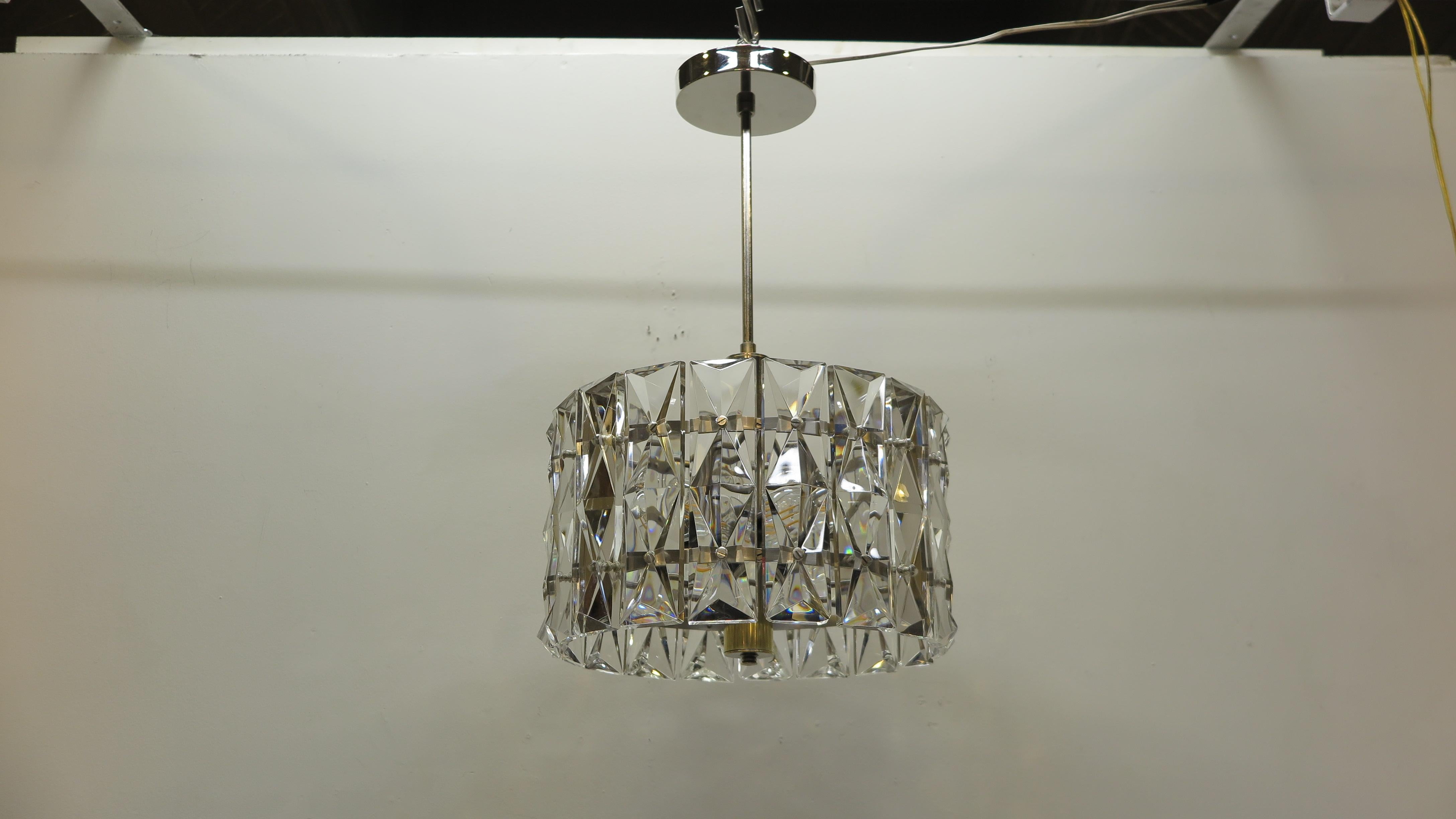 Midcentury pendant light of prism faceted cut crystal glass. Midcentury Kinkeldey pendant light high quality having thick facet cut prism crystal glass chards suspended on stainless steel circular cage with a nickel cylinder shaft. Light capacity