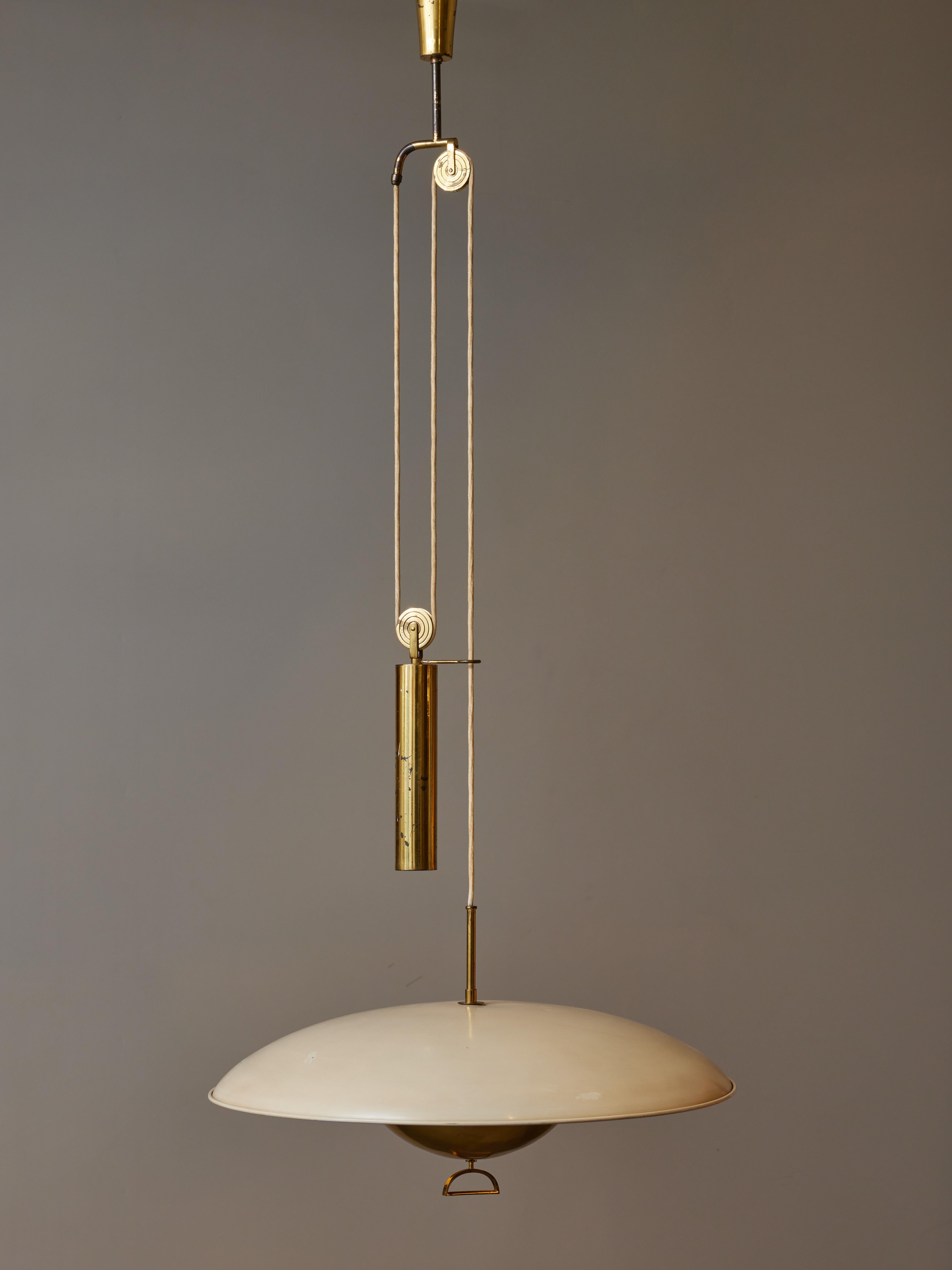 Decorative and ingenuine fixture made of an enameled metal shade with brass diffuser, hung by the wire which goes through different pulley and tubes allowing the fixture to be adjustable in height thanks to the counterweight.