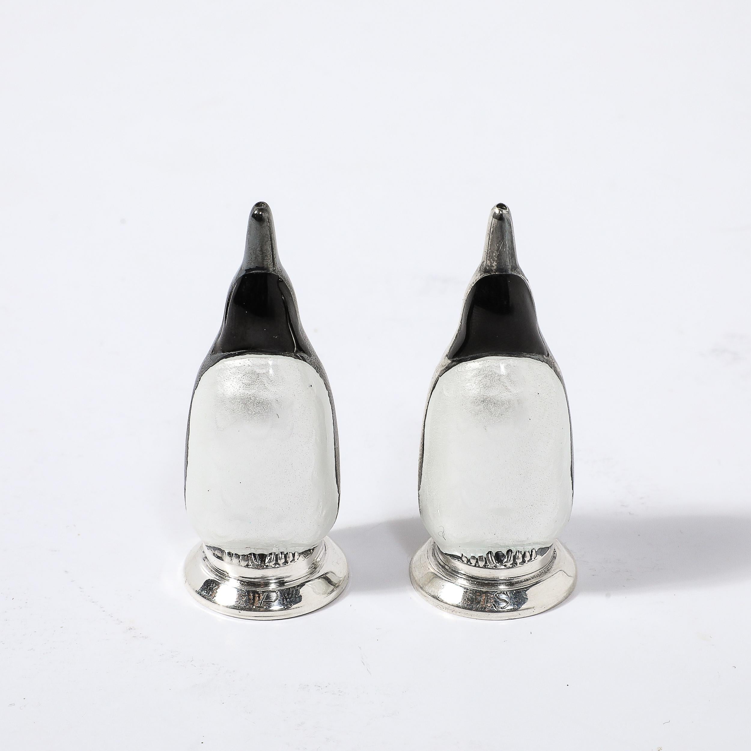 This beautiful pair of Mid-Century Modernist Solid Sterling Silver 925 Guilloche Enamel Salt/Pepper Shakers Penguins signed MEKA originates from Denmark, Circa 1950. These shakers are sculptural renderings of penguins in sterling silver and