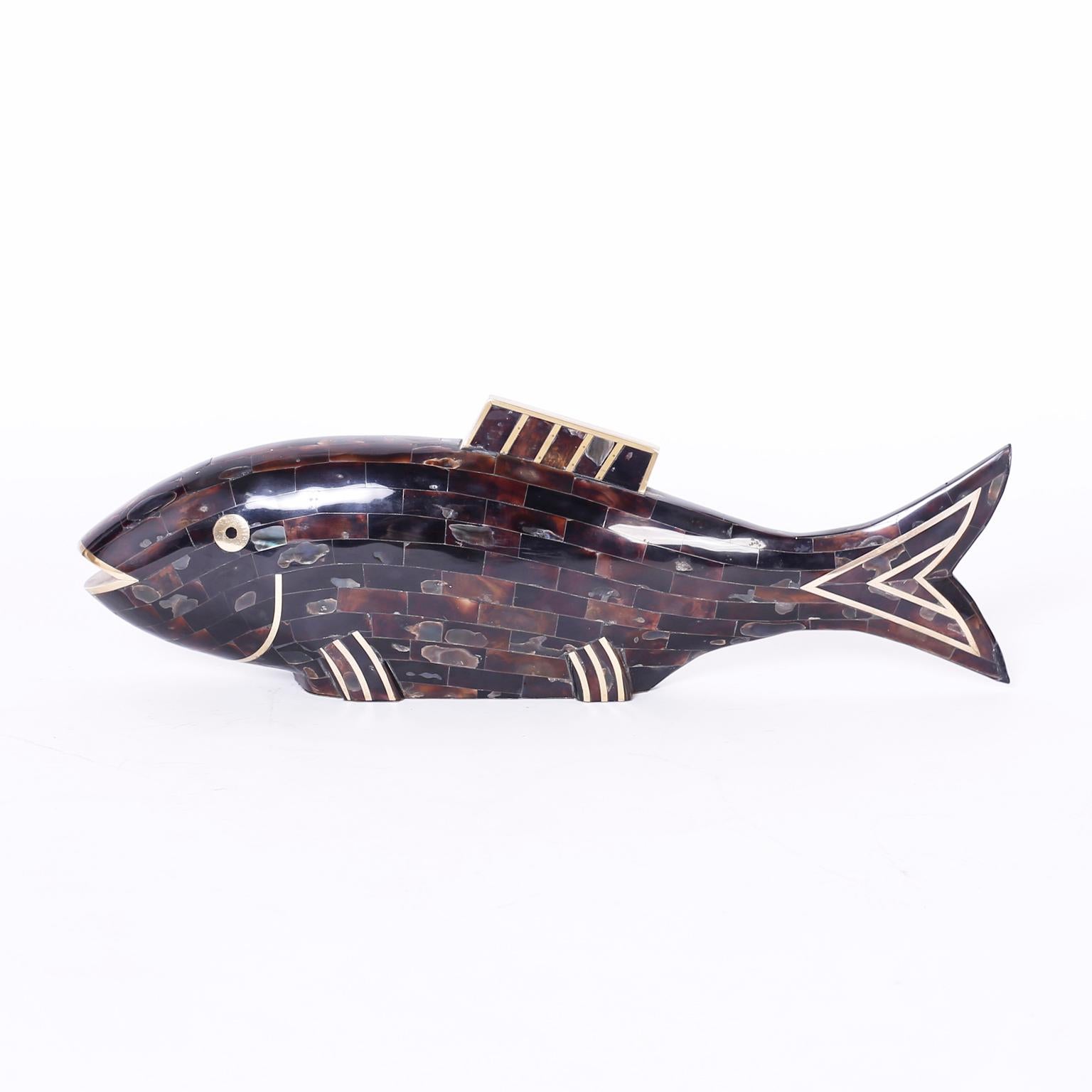 Midcentury stylized fish crafted with penshell in a tessellated technique with brass highlights. Signed Maitland-Smith on the bottom.