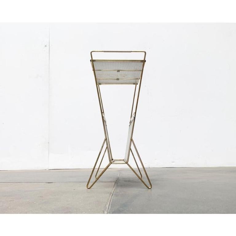 Mid-Century Perforated Metal Magazine Holder and Side Table, 1960s, in Very Good conditions. Designed 1960 to 1969.

Additional information:
Material: Metal
Color: Gold
Styles: Mid-Century Modern
Item Type: Vintage, Antique or Pre-owned
Diamension: