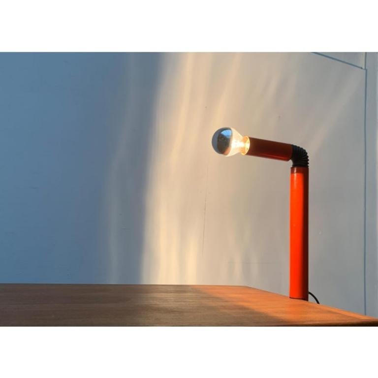 Rare table lamp by Stilnovo according to a design by Danilo & Corrado Aroldi from the 60s.

The luminous body consists of a simple tube, which is separated in the upper third and provided with a joint. The joint is obscured with an elastic hose