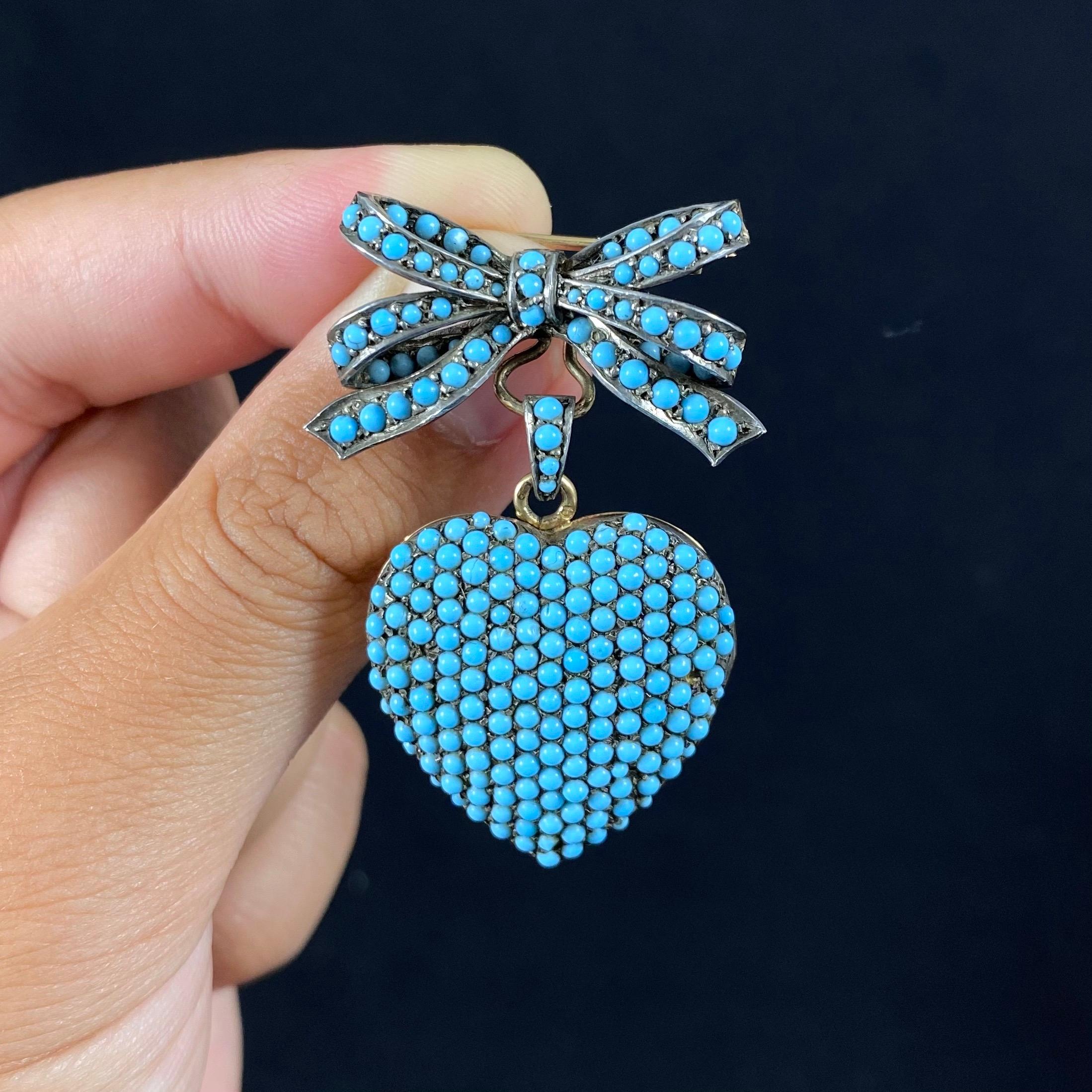 Mid-Century Persian turquoise heart and bow convertible locket brooch in 19.2kt yellow gold and silver, Portugal. This romantic jewel of Victorian inspiration is pavé-set throughout with circular Persian turquoise cabochons of an incredible sky-blue