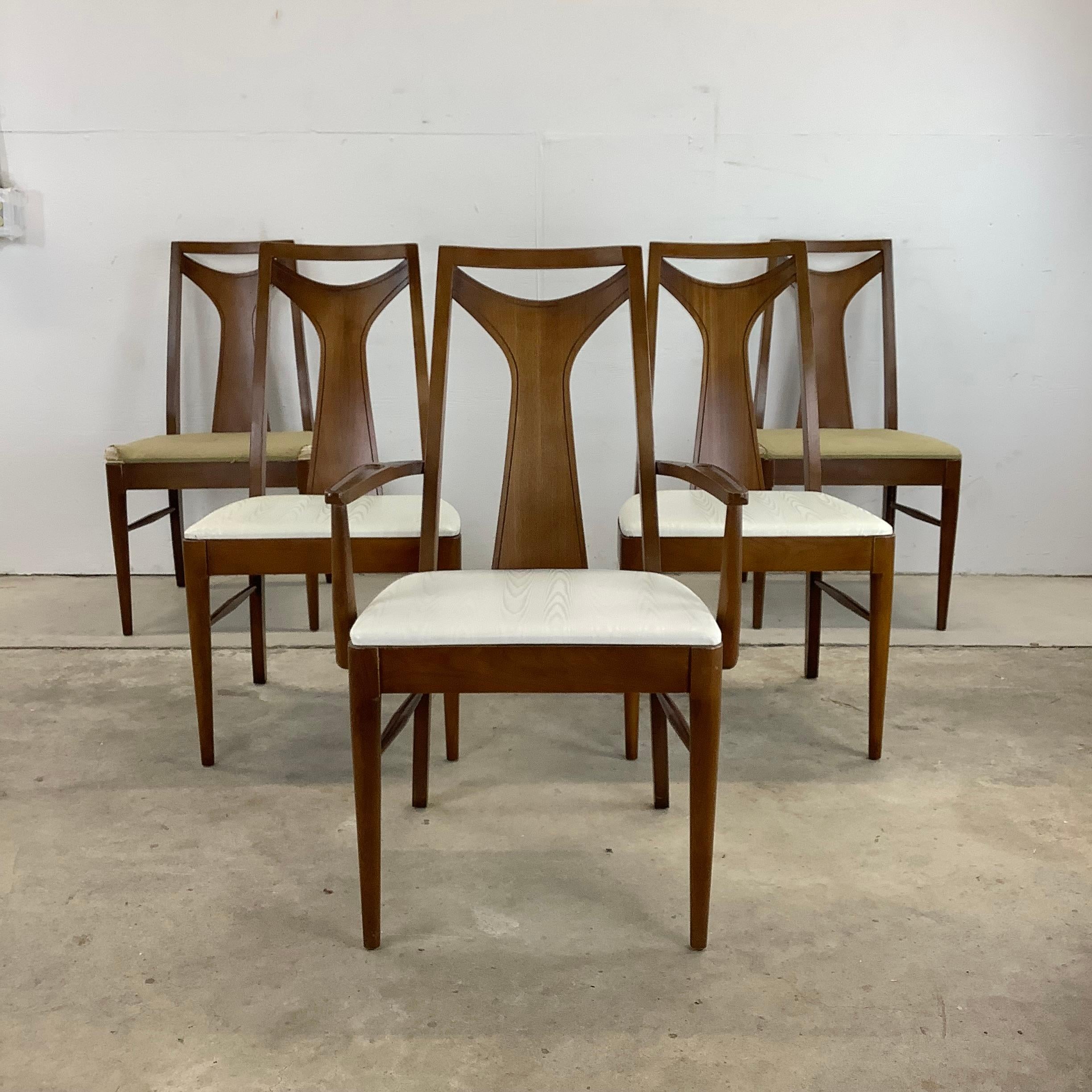 This set of five vintage walnut dining chairs from Kent Coffey's Perspecta line includes a set of four side chairs and matching armchair. The comfortable proportions and stylish highback design make these the perfect addition to any dining room