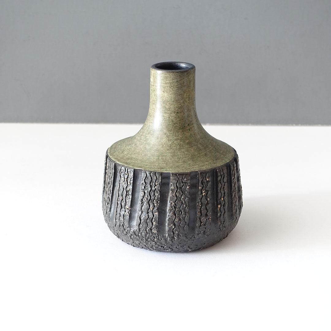 Hand-made studio pottery from Sweden by Mari Simmulson while she worked for Upsala-Ekeby. It’s from her line called “Peru.” The overall height is 5 inches. It features sgraffito designs carved into earthenware. In production from 1953–1966. 

Mari