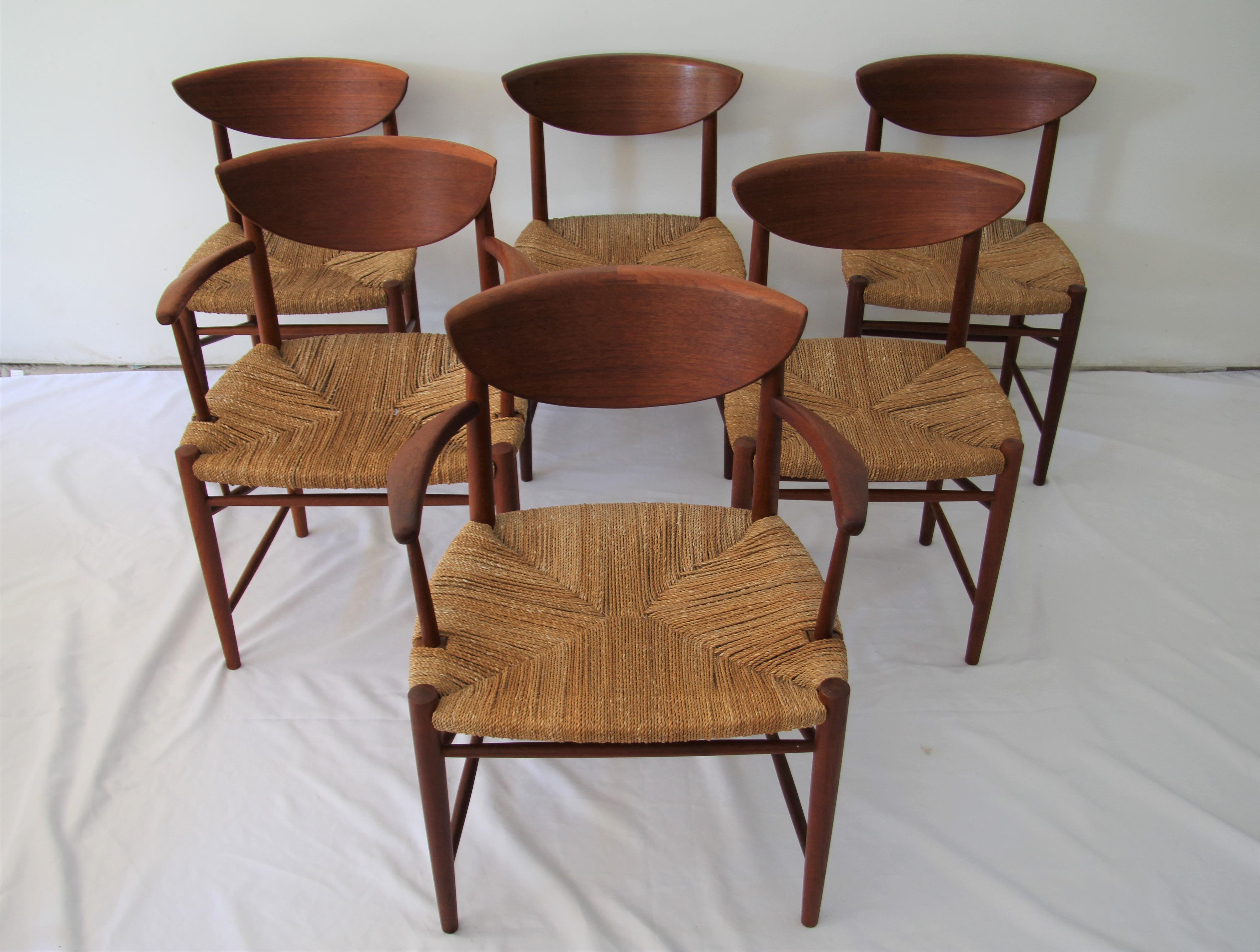 Set of six Peter Hvidt and Orla Mølgaard-Nielsen for Soborg Mobler model 316 dining chairs includes 2 armchairs and 4 side chairs. These sculpted chairs are made of teak with rush seats that are intact with no loose cords or staining. Chairs have