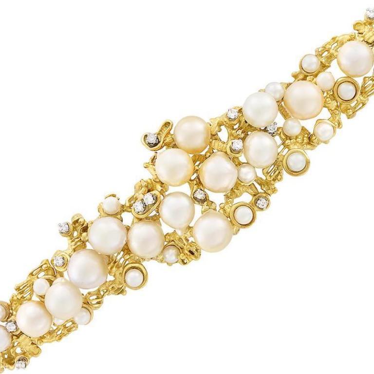 Impressive mid century modern Peter Lindeman 18 karat gold cultured pearl  semi-baroque diamond strap bracelet is set in heavy 18k gold with 37 gorgeous pearls measuring approximately 10.0 to 4.2 mm, 14 round diamonds totaling 0.85 carats.

The