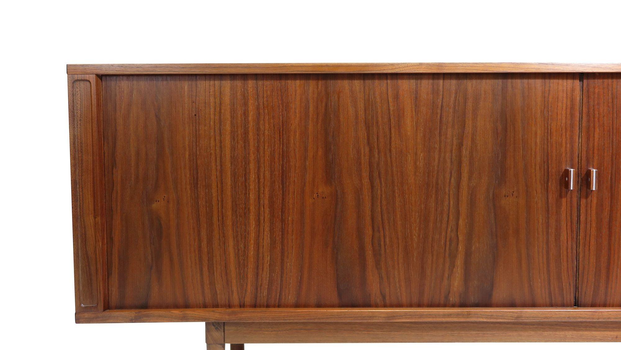 Walnut credenza designed by Danish designer, Peter Lovig Nielsen, 1965 Denmark. The cabinet is crafted of walnut with tambour doors, which open to reveal an interior with adjustable shelves and silverware drawers. The cabinet is fully restored and