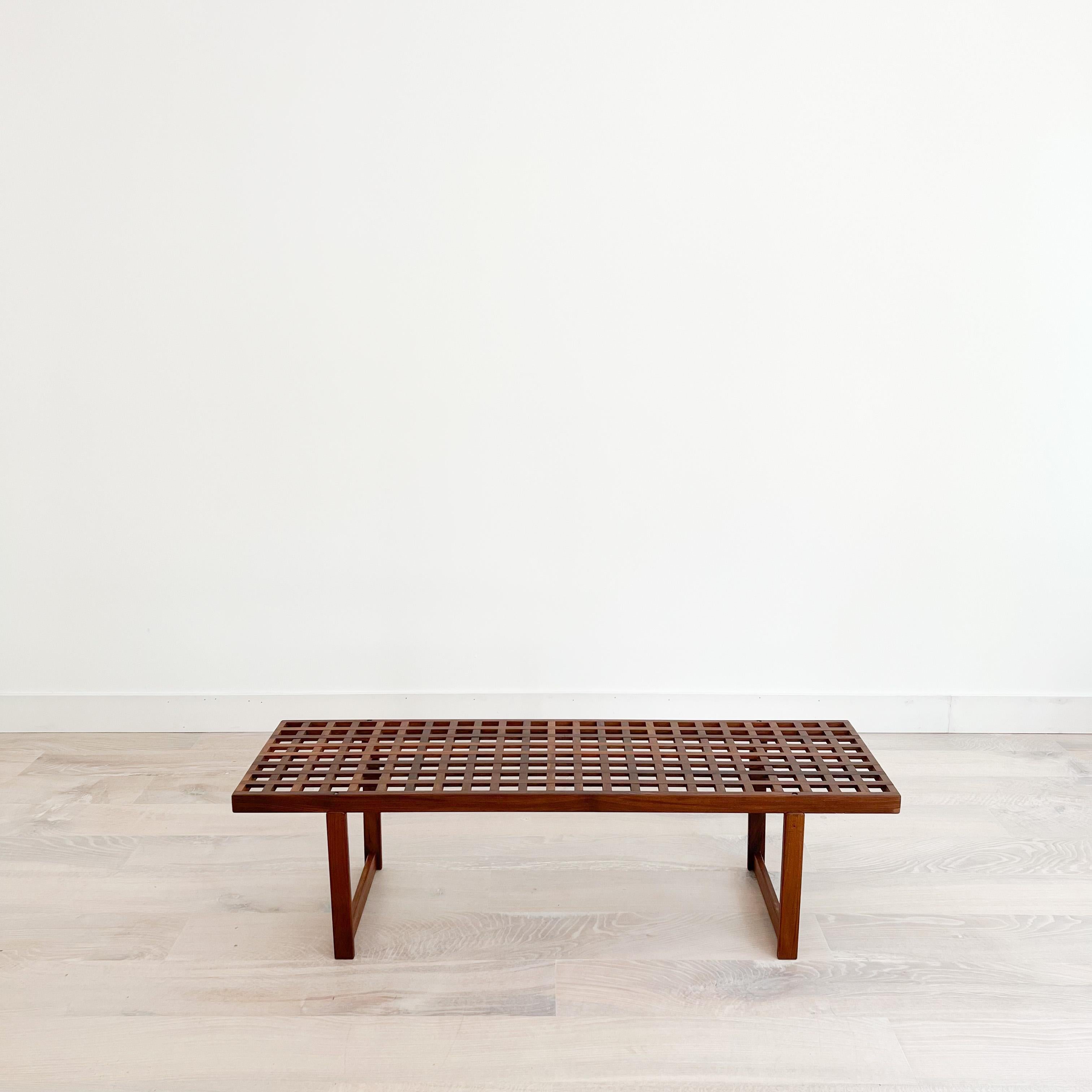 Hard to find Mid-Century Modern Peter Løvig Nielsen lattice coffee table/bench. The teak wood is in great condition overall. Some light scuffing/scratching from age appropriate wear.