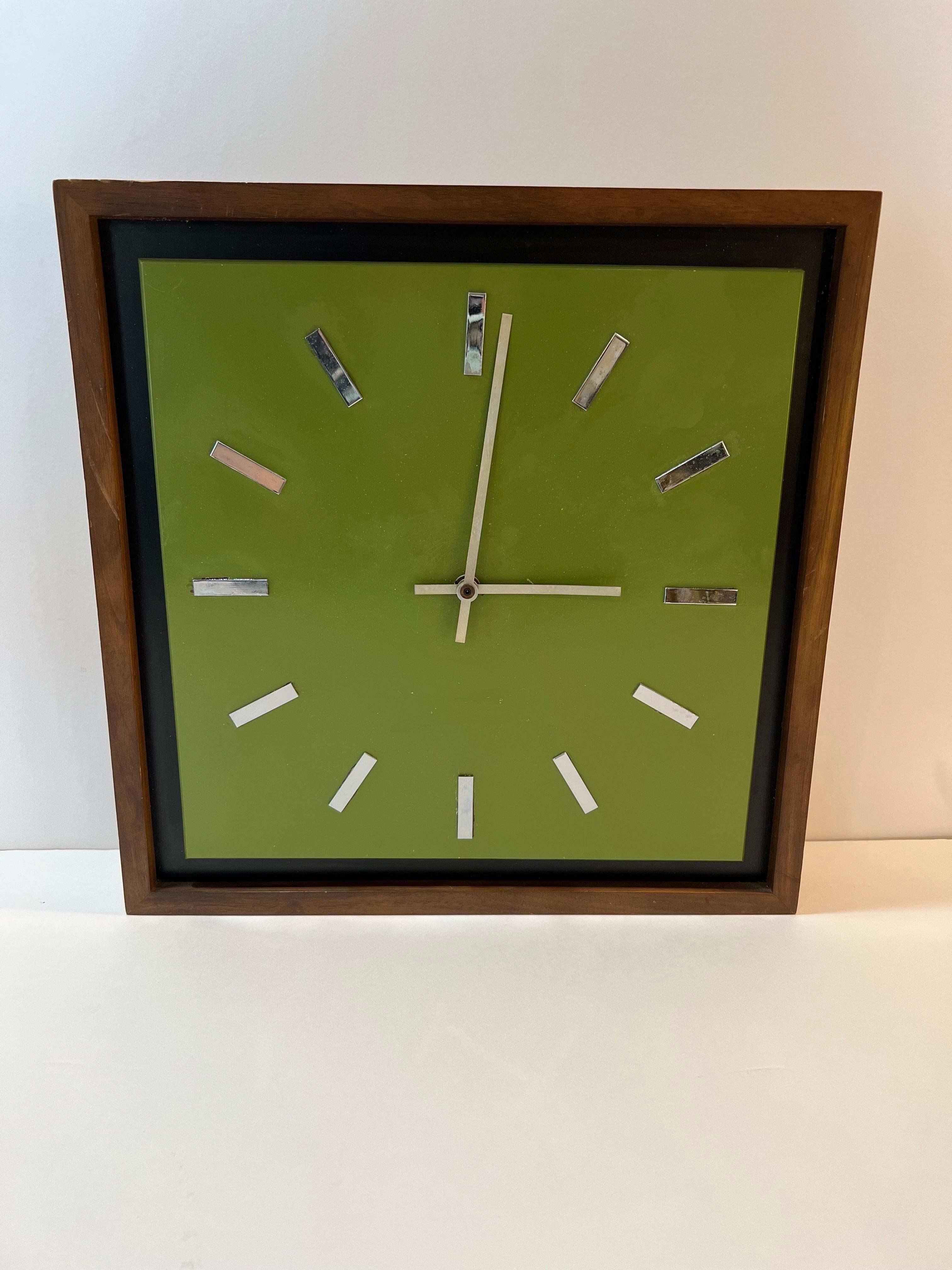 Midcentury Peter Pepper Wall Clock . Classic avocado green background with all wooden frame. Chrome digits make up this minimalist clock face. Works perfectly on a large C battery.