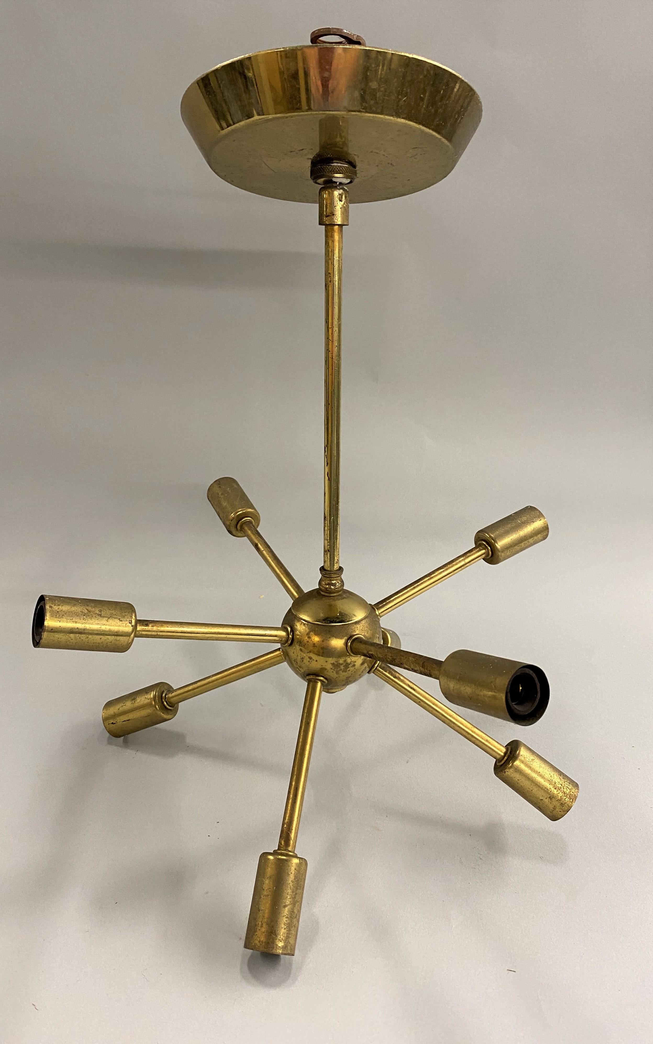 A fine midcentury Space Age design petite Sputnik 8-light brass chandelier with canopy. The first satellite that ever orbited the earth was the Soviet Union's Sputnik satellite, launched in 1957. Soon thereafter the launch inspired the creation of