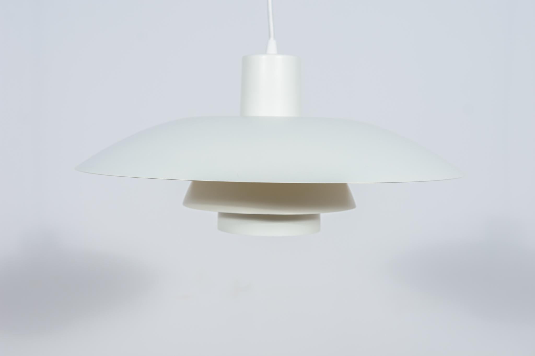 This pendant was designed by Poul Henningsen and produced by Louis Poulsen from 1966 until it was discontinued in this color in the late 1970s to early 1980s. It is made of powder-coated aluminum and is lit both downwards and from the sides. The PH